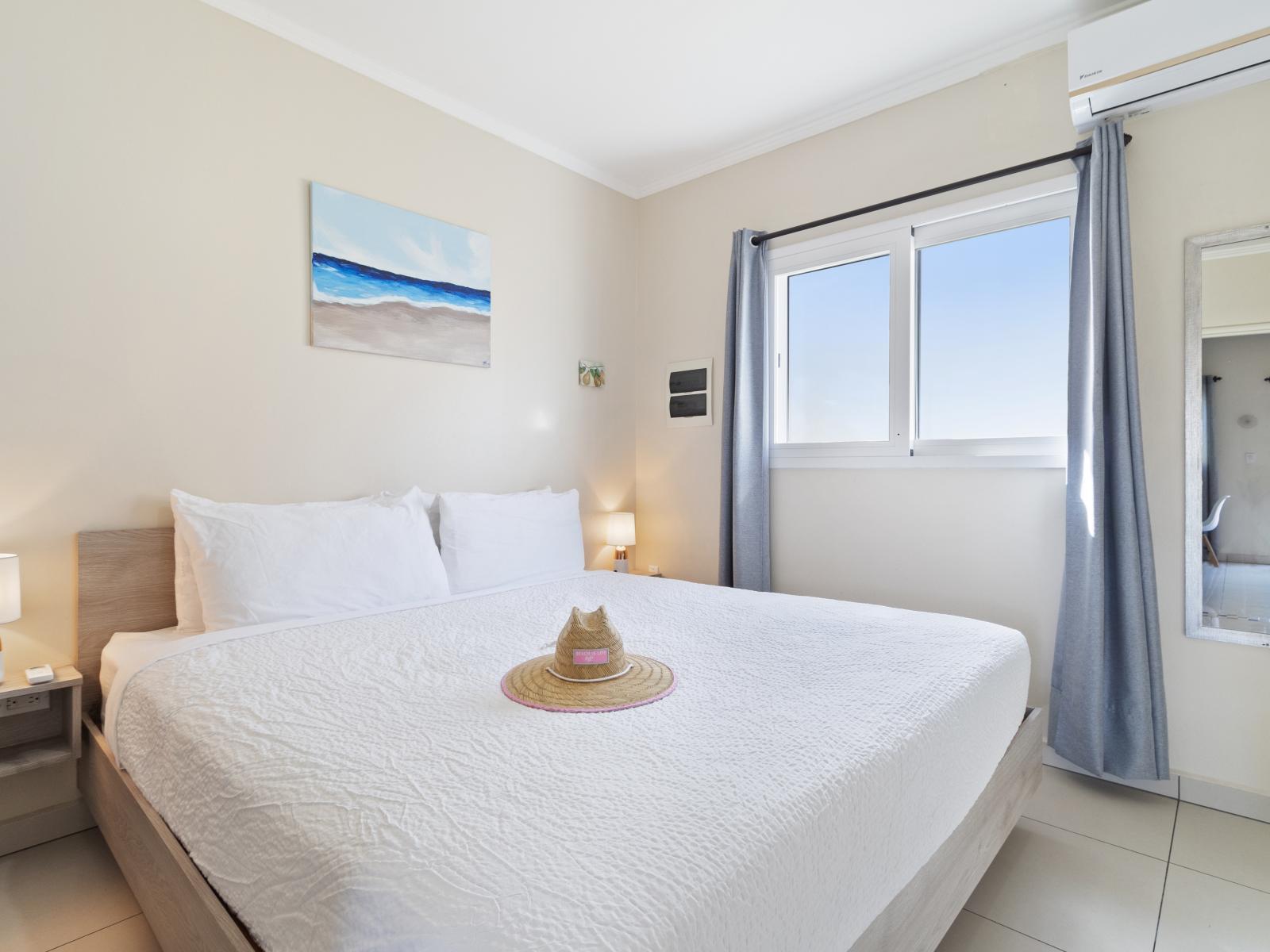 Majestic Bedroom of the Apartment in Noord Aruba - Bright and airy bedroom with large windows for natural illumination - Thoughtfully designed bedroom featuring functional and stylish furniture - Comfy Bed and Beautiful Full size Mirror