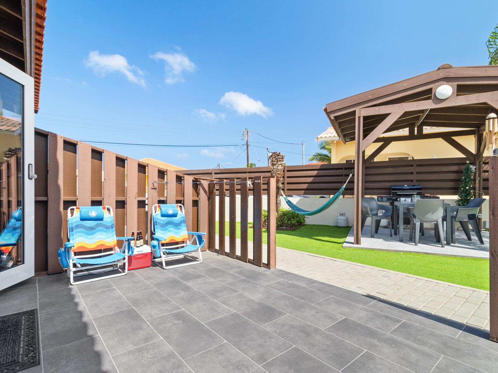 Outside Patio Area of the Apartment in Noord Aruba - Embrace a relaxed atmosphere in the great outdoors - Access to Pool Area - Attractive patio furniture and decor