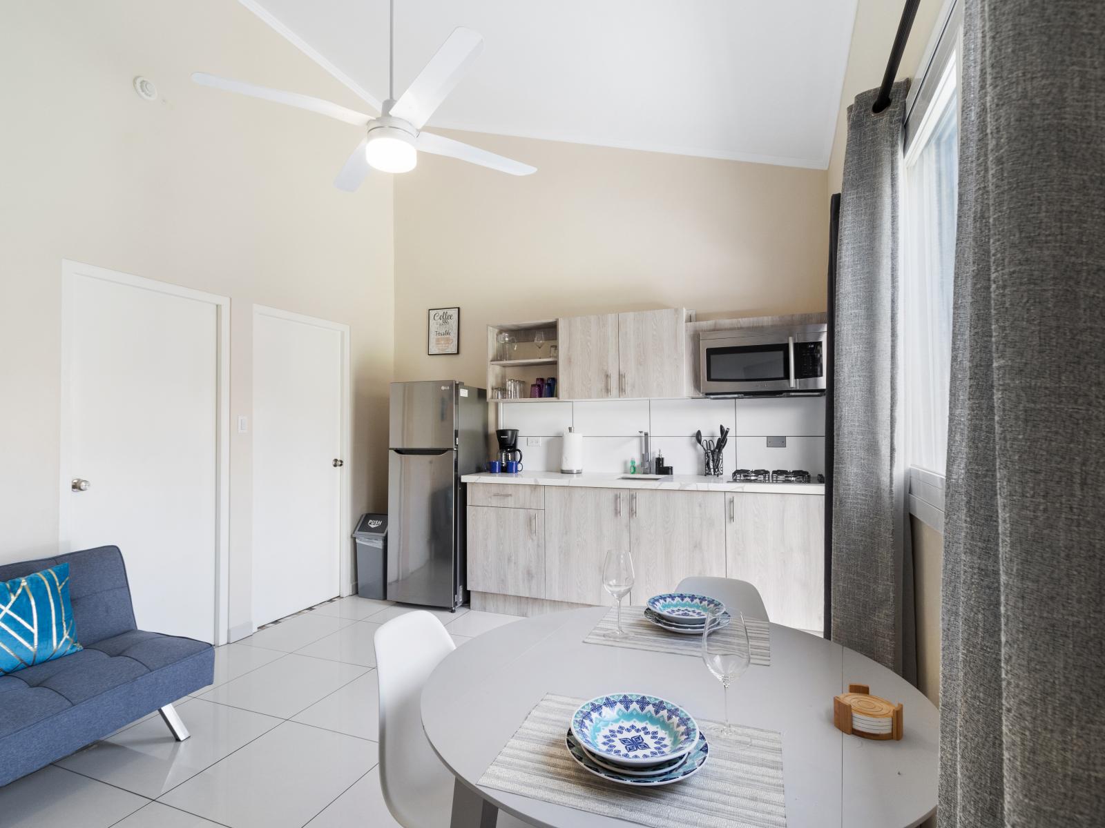 Pompous Dining and kitchen Area of the Apartment in Noord Aruba - Dining table for two and kitchen - Open layout seamlessly connecting the dining area to the kitchen and living room - Stylish dining space with chic furnishings