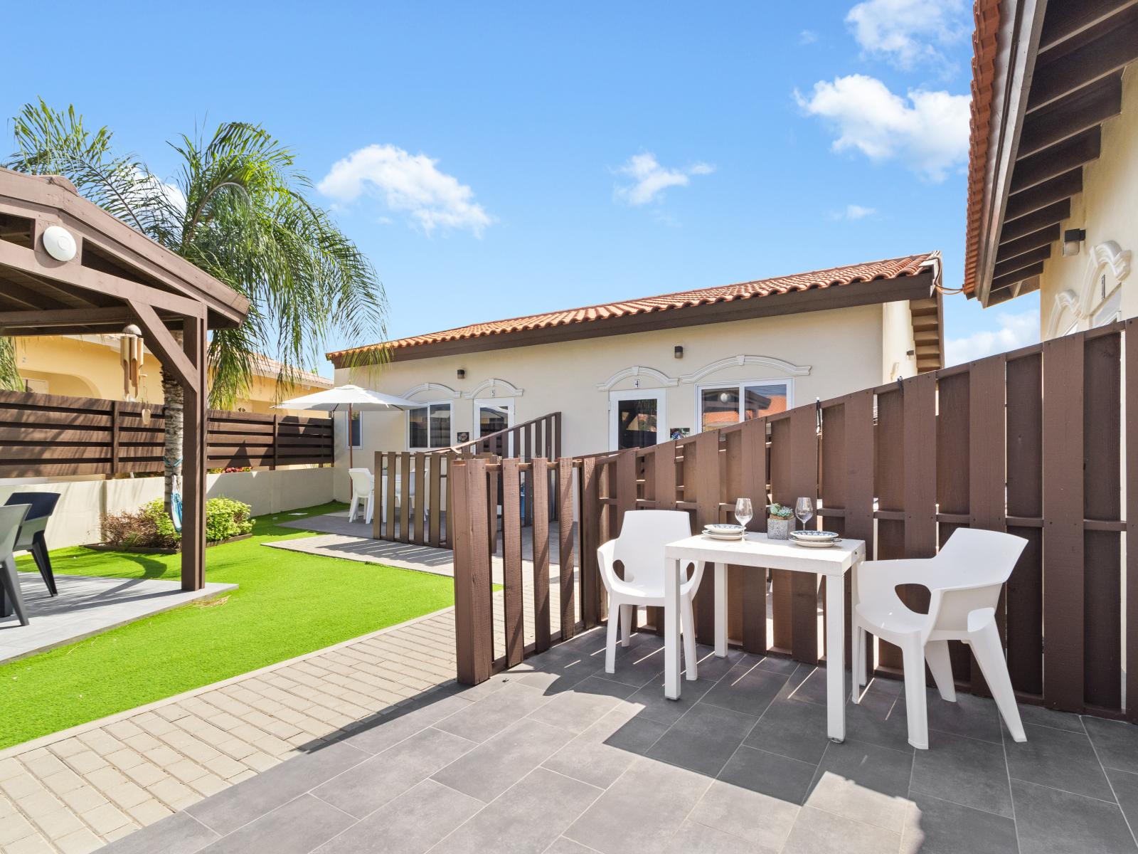 Lovely outdoor dining area of the Apartment - Outside patio with dining table - 2 Persons Dining - Sun-kissed comfort awaits in our outdoor sanctuary