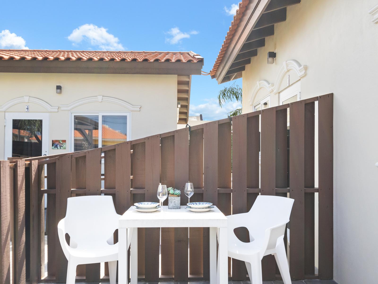 Lovely outdoor dining area of the Apartment - Outside patio with dining table - 2 Persons Dining - Sun-kissed comfort awaits in our outdoor sanctuary