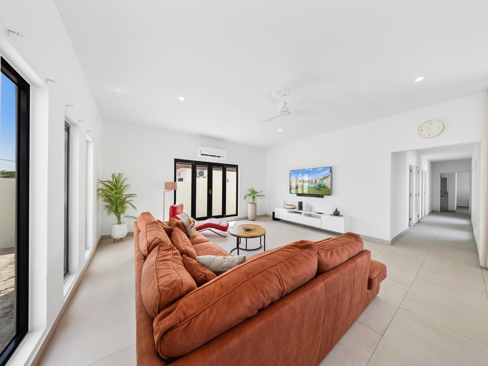 Inviting living area of the home in Noord, Aruba - Providing plenty of seating with arrangement of cozy sofas for relaxation and socializing - Enjoy a bright and airy living room with large windows letting in plenty of natural light.