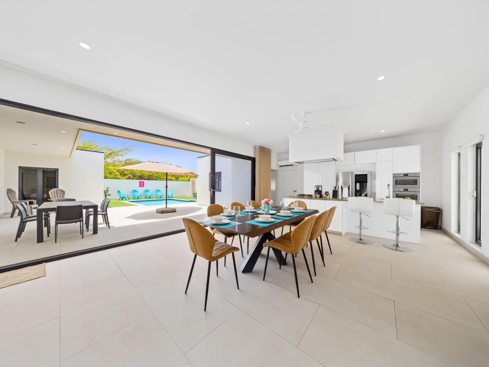 Beautifully appointed dining area of the home in Noord, Aruba - Large glass sliding door gives you access to the backyard and pool - Designed to create a relaxing and enjoyable dining experience.