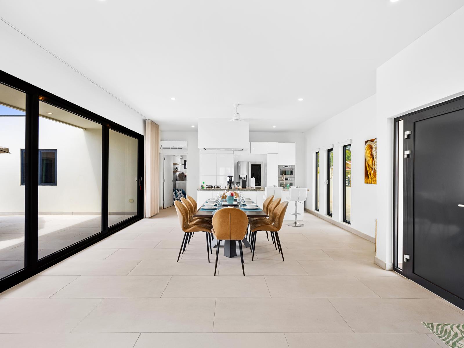 Comfortable dining area of the home in Noord, Aruba - Open concept dining area and kitchen seamlessly connected for your convenience - Contemporary design with elegant lines and stylish décor. - Beautifully set dining table for memorable meals.