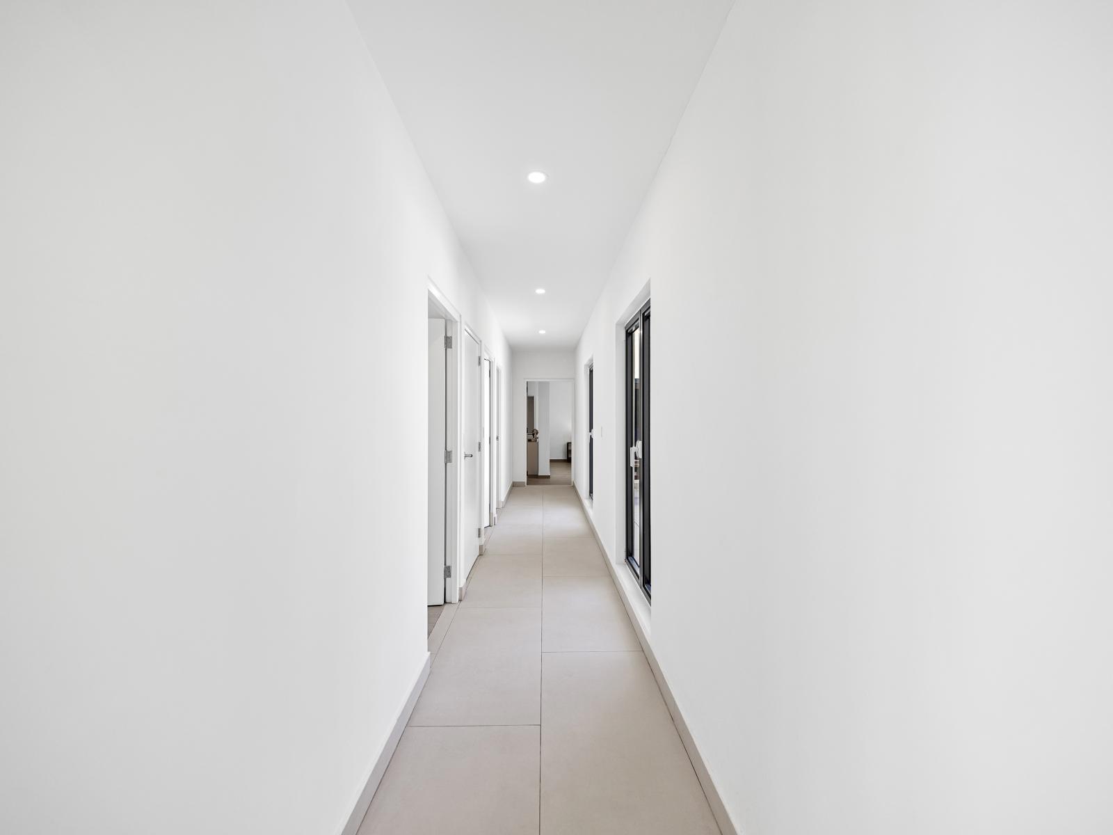 Step into a cozy and inviting hallway leading you to your relaxing bedrooms. - Make a grand entrance to the bedrooms through our tastefully designed hallway - Connect effortlessly with each bedroom as you journey through our well-connected hallway.