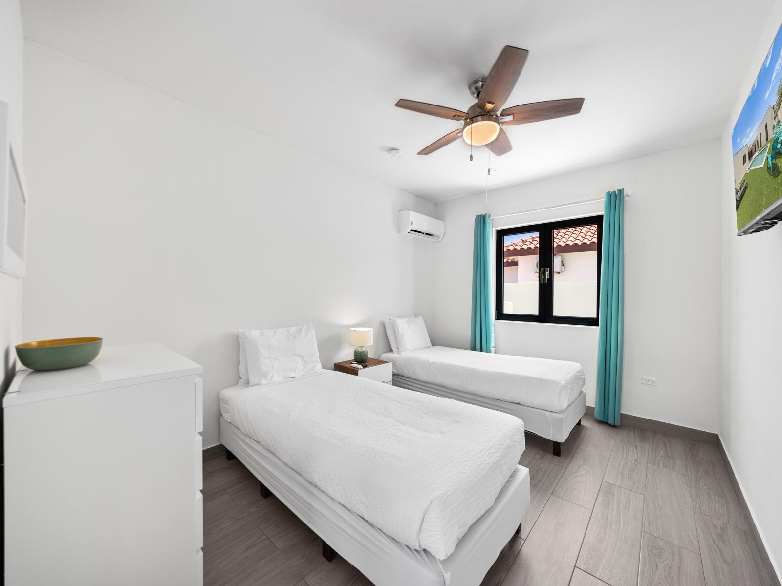 Experience serenity in our peaceful bedroom of the home in Noord, Aruba - Features twin single beds with neat and clean linen - Immerse yourself in its relaxing ambiance, a blend of elegance and cozy charm.