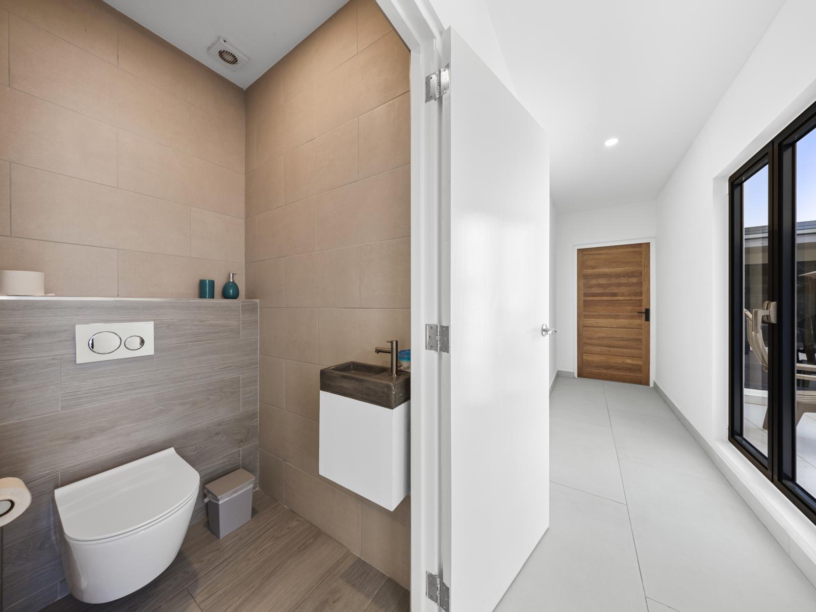 Discover the ease of access with our conveniently located half bathroom in the hallway of the apartment in Noord, Aruba - Take a moment to refresh in our well-appointed half bathroom conveniently situated in the hallway