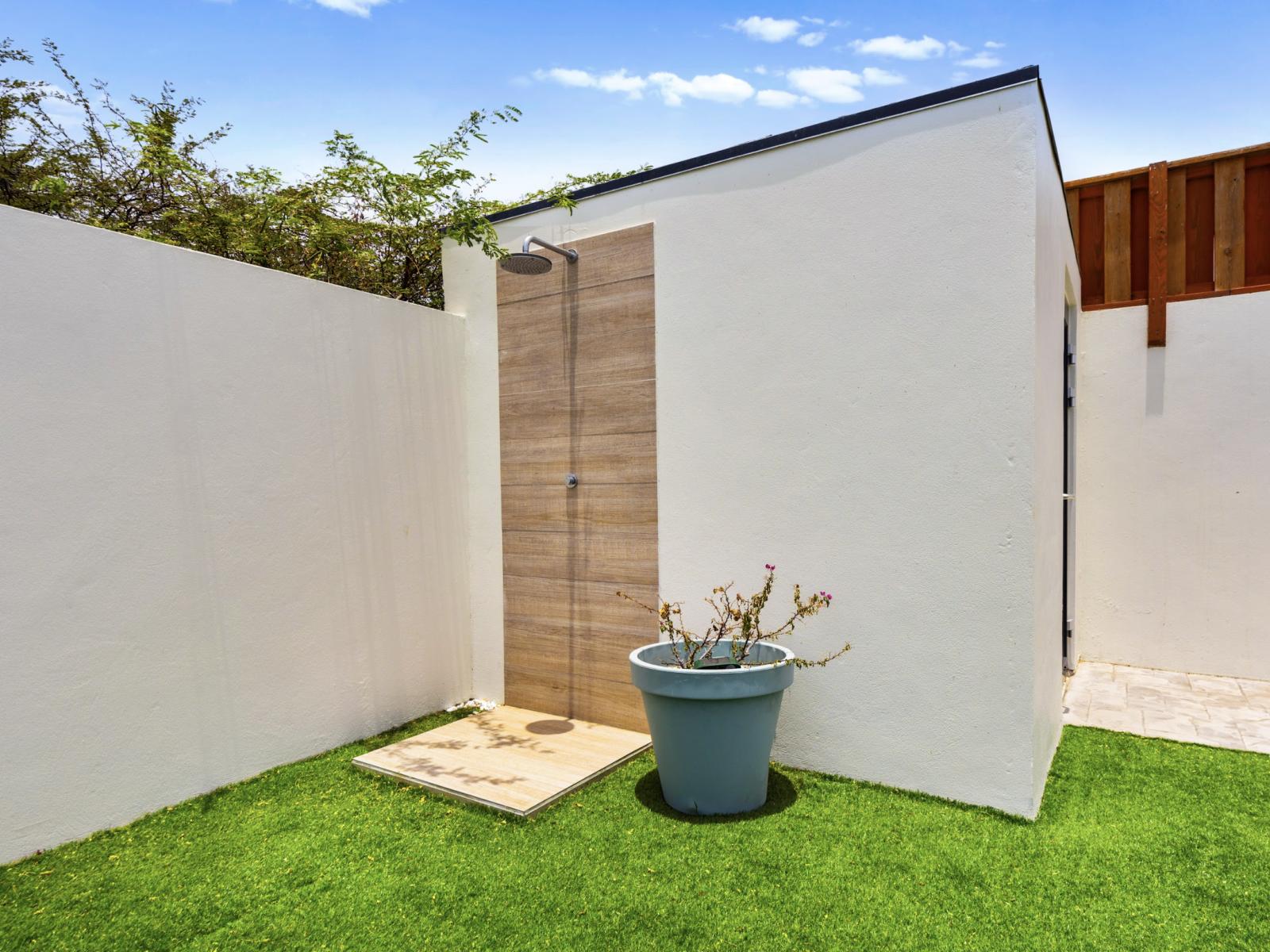 Indulge in the ultimate relaxation at our open-air outdoor shower area. of the home in Noord, Aruba - Escape to our open-air outdoor shower area for a refreshing and rejuvenating experience. - Wash away your cares at our open-air outdoor shower.