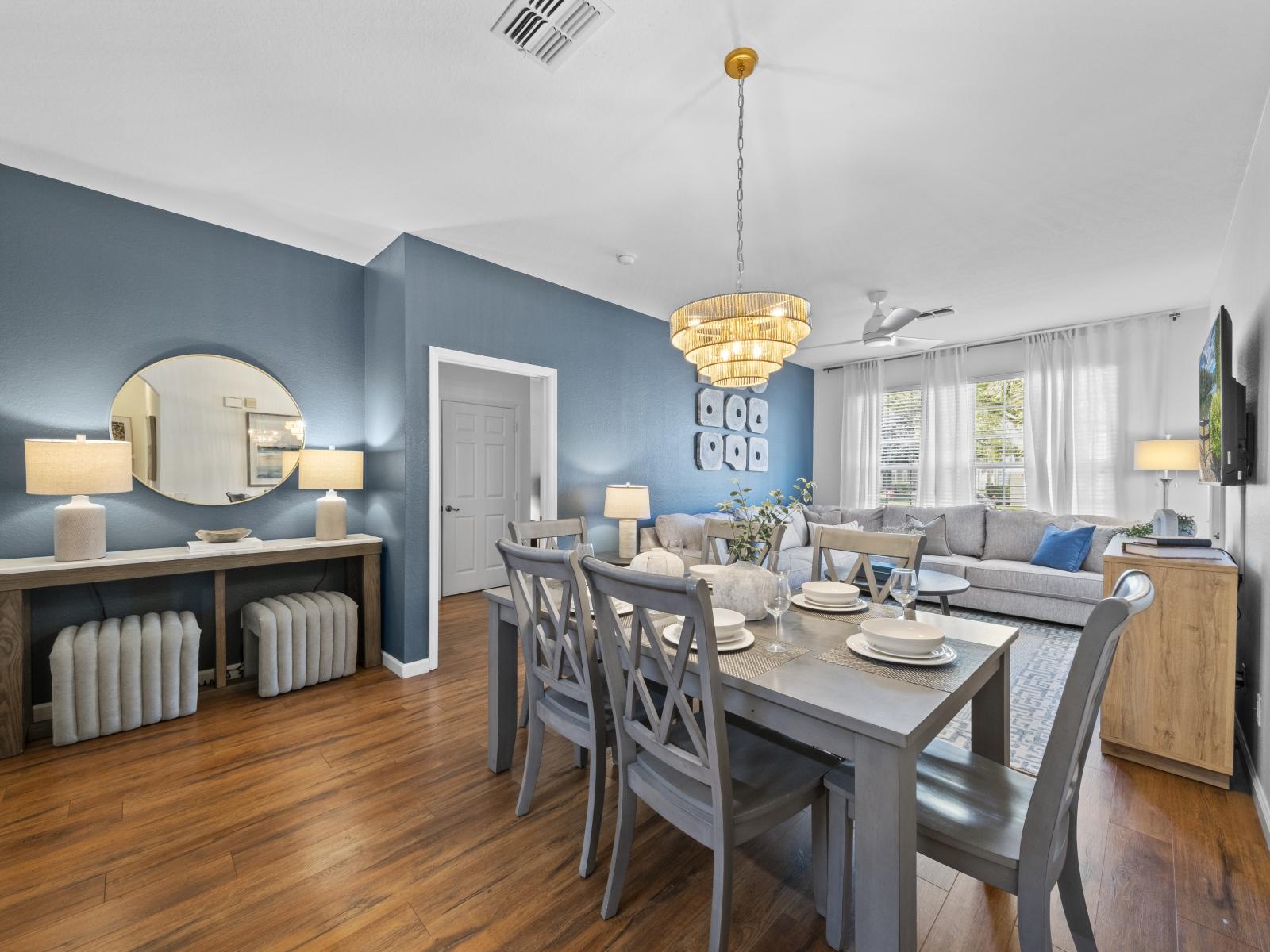 Alluring 6 persons dining area of the condo in Kissimmee, Florida - Cohesive blend of colors with lively accent tones to enhance visual appeal - Trendy dining space showcasing a fashionable table paired with modern seating