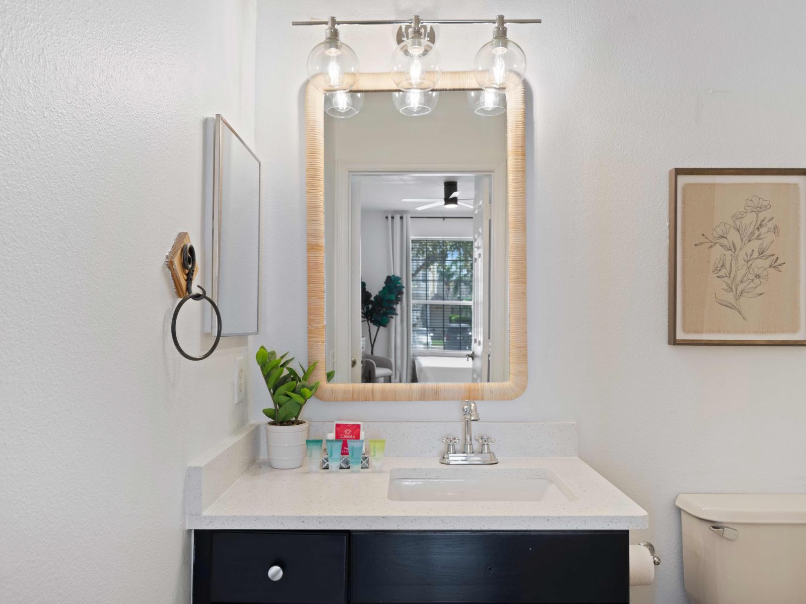 Classy bathroom of the condo in Kissimmee, Florida - Stylishly designed with a modern vanity and luxurious lighting fixtures - Spotless and well-maintained, with no visible clutter or grime - Availability of all bathroom amenities