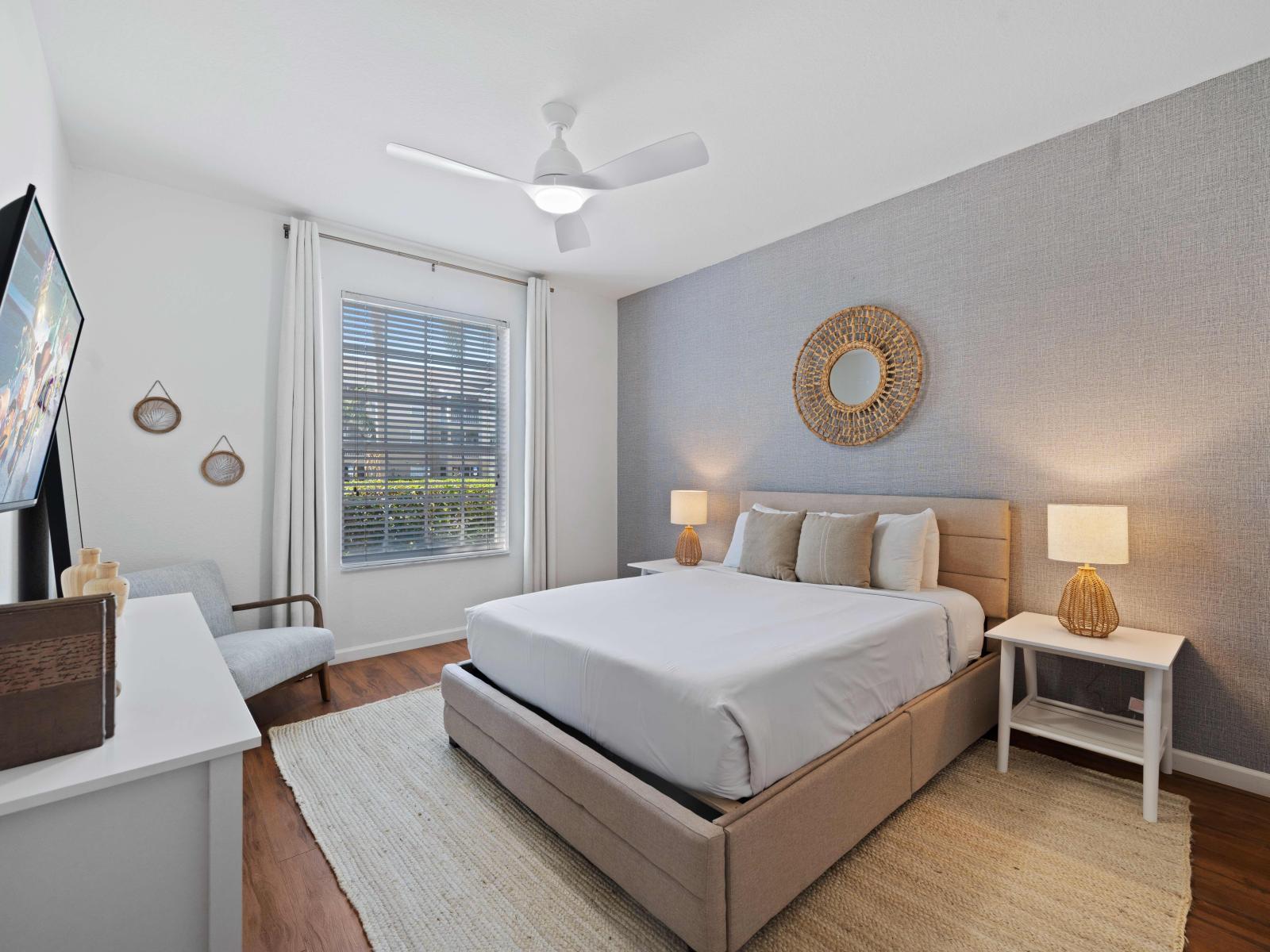 Graceful bedroom of the condo in Kissimmee, Florida - Minimalistic approach, providing a serene space for ultimate relaxation - Double bed with plush bedding and soft pillows - Magnificent table Lamps - Availability of TV and Netflix