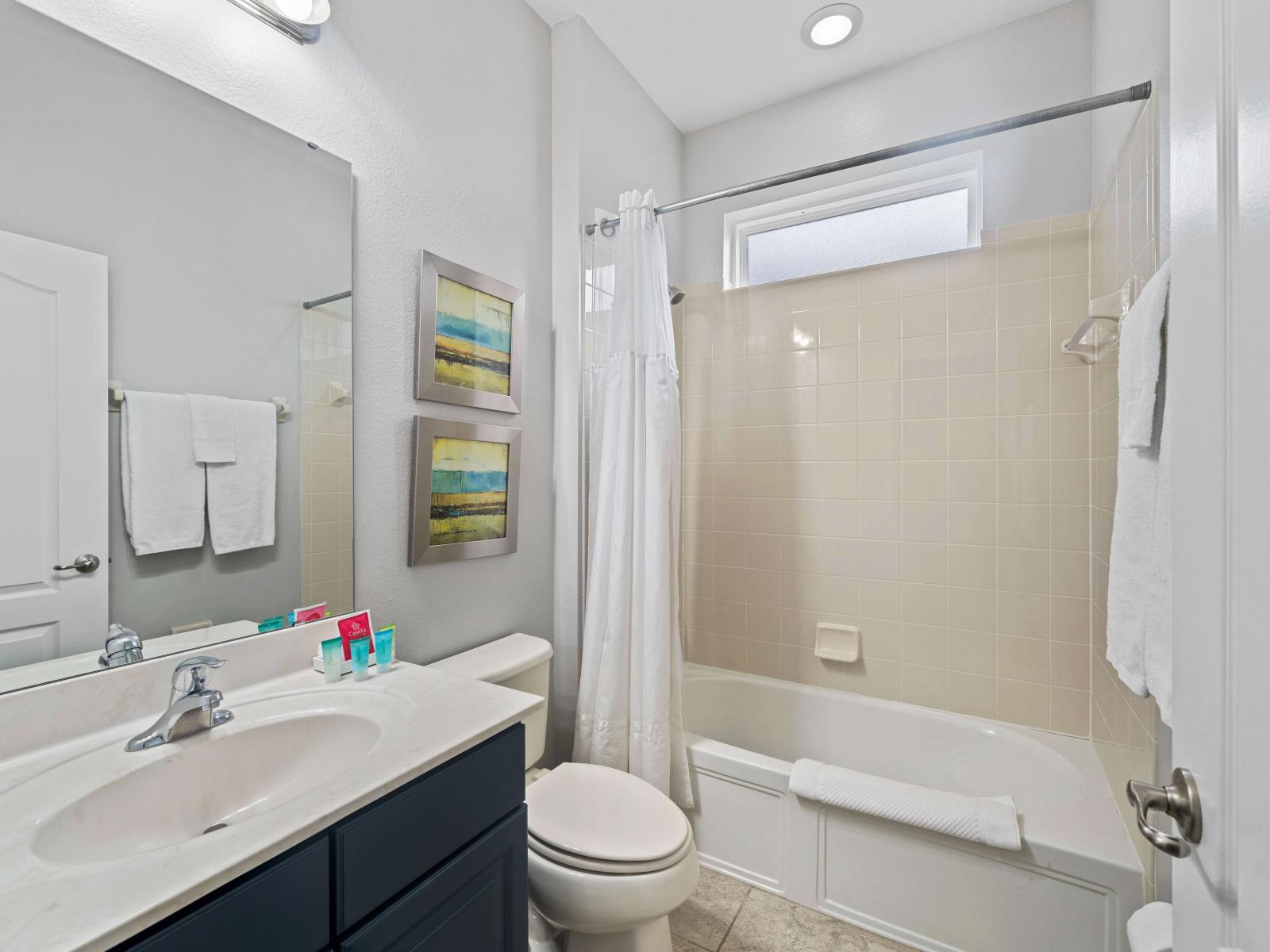 Bathroom 3 with a bathtub and shower combo