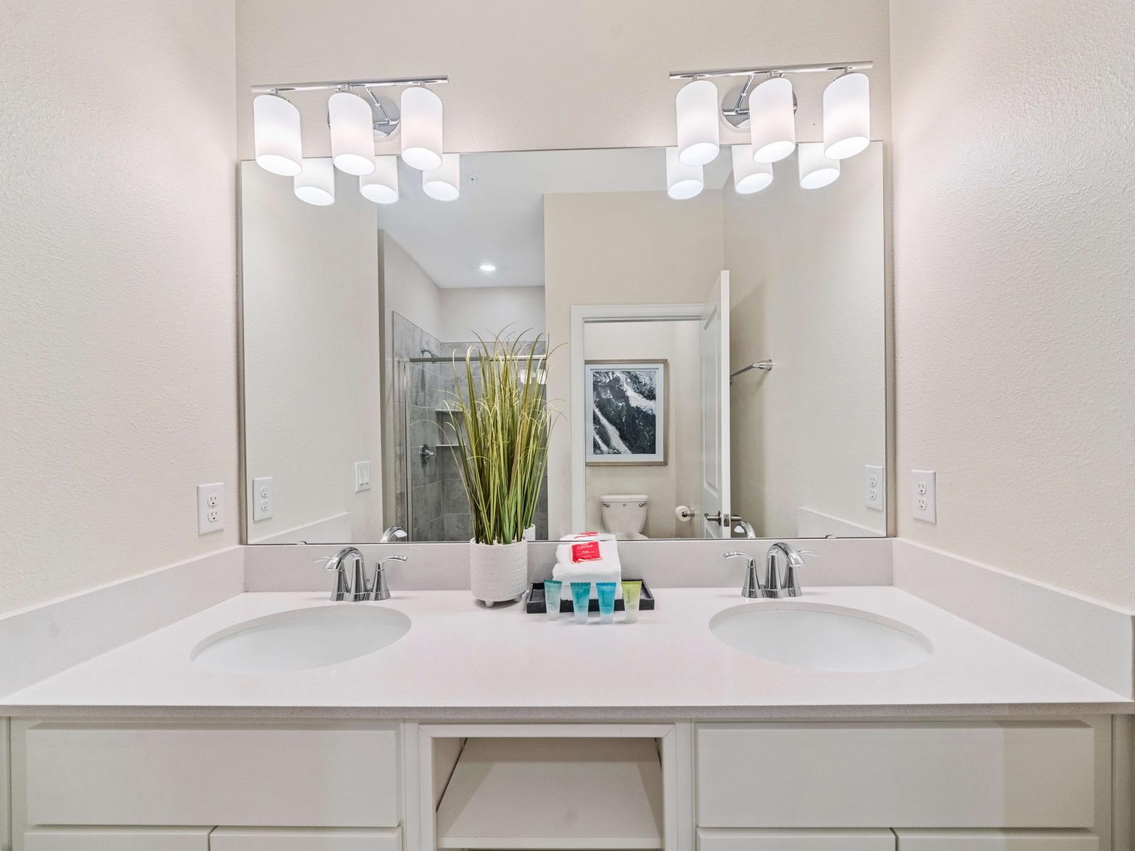 Excusive Bathroom of the apartment in Kissimmee - Beautiful Vanity with large size wall mirror - Sufficient storage space - Neat and clean toilet seat - Availability of all bathroom amenities - Stunning glass cabin shower area