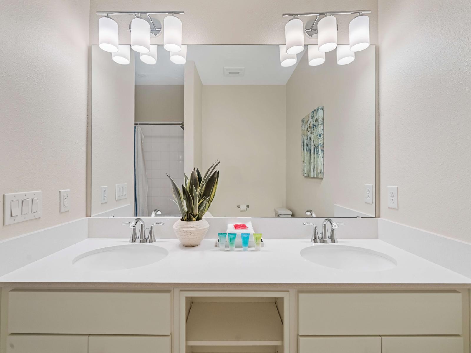 Excusive Bathroom of the apartment in Kissimmee - Beautiful Vanity with large size wall mirror - Sufficient storage space - Neat and clean toilet seat - Availability of all bathroom amenities - Stunning glass cabin shower area