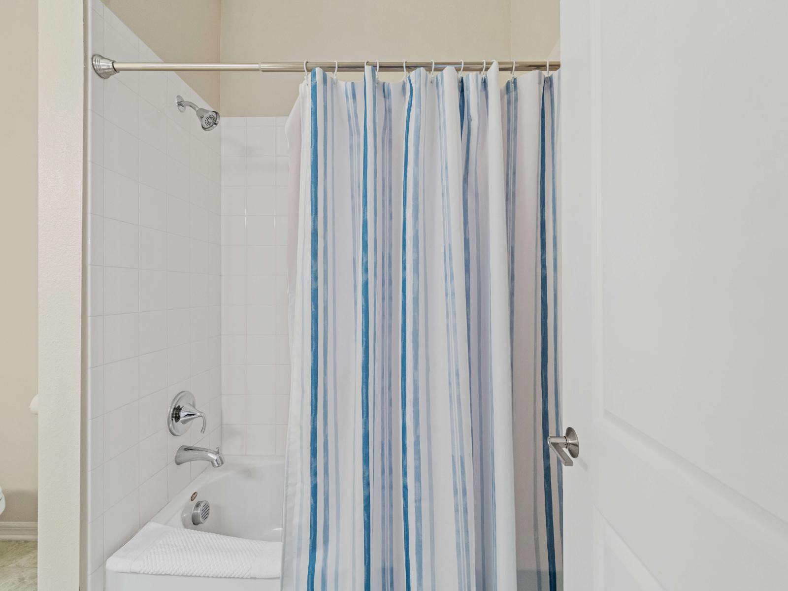 Bathroom 2 with a bathtub and shower combo