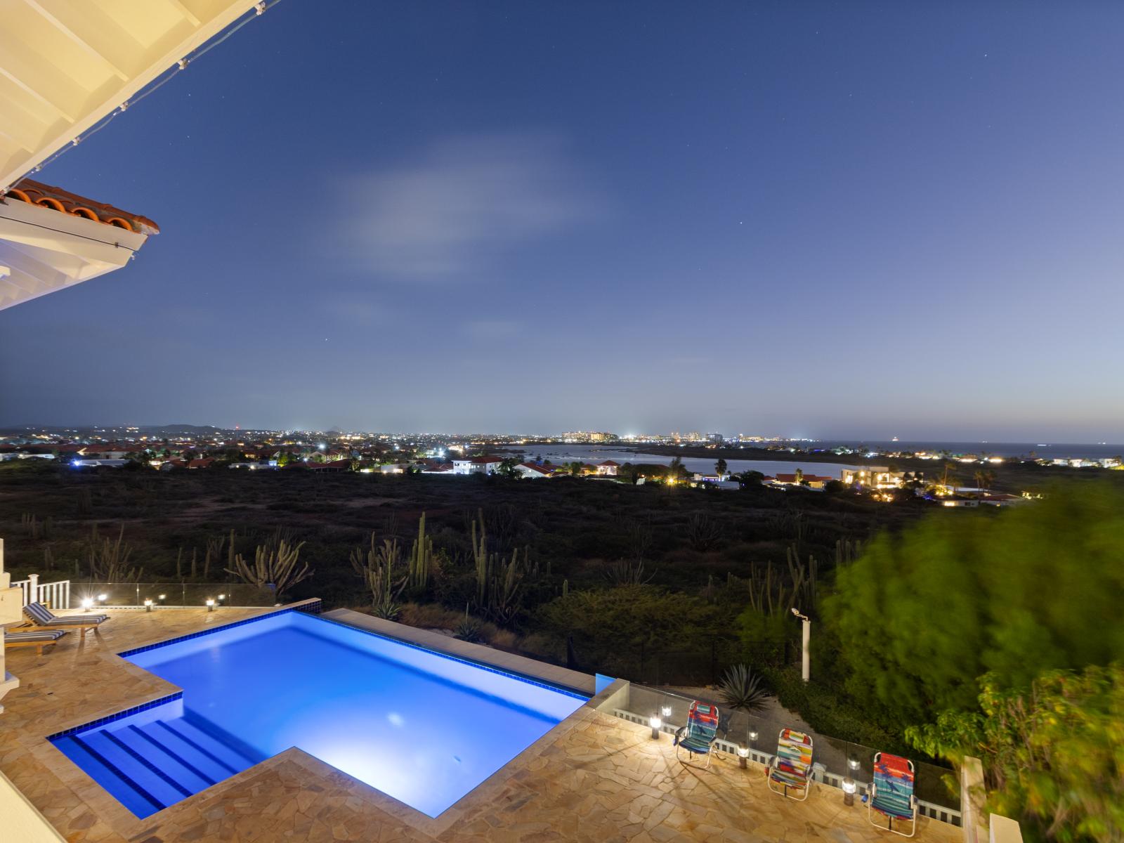 Stunning pool view at night, illuminated for a perfect evening ambiance.