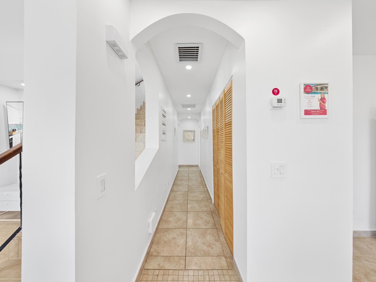 Hallway to the bedrooms of the condo in Noord Aruba - Experience the calmness of our hallway leading to your sleeping haven - Transitional elegance at its finest