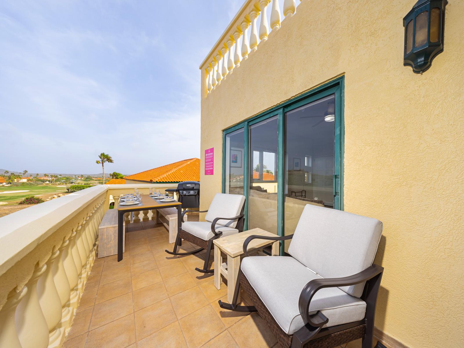 Cozy outdoor seating area with distant views of downtown Aruba and the cruise port of the condo in Noord - Easy access to a private balcony for outdoor moments with dining and BBQ - Private oasis with a sense of tranquility