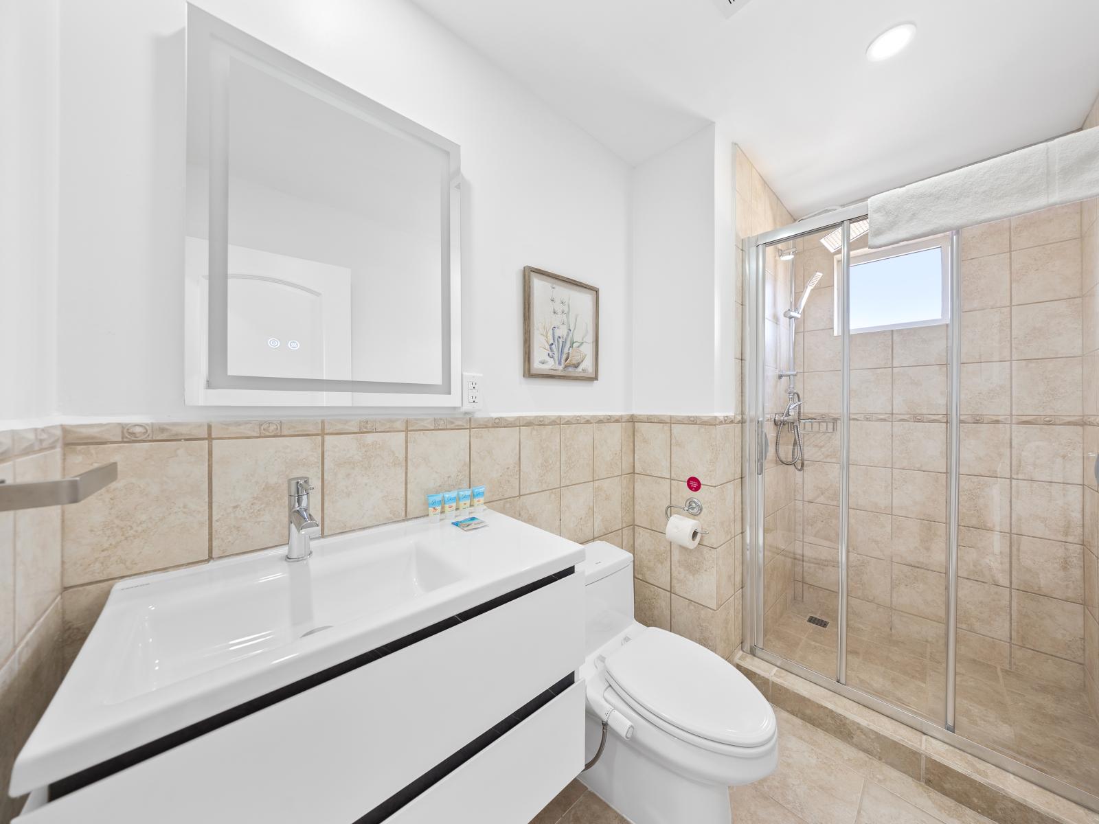 Swish bathroom of the condo in Noord Aruba - Features a walk in shower stall - Contemporary fixtures for a touch of indulgence - Attention to detail, from the elegant tiles to the faucets