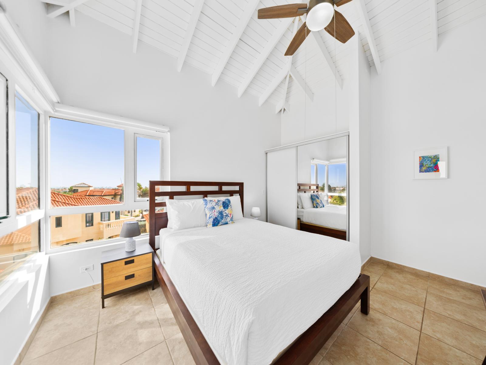 Captivating bedroom of the condo in Noord Aruba - An abundance of natural sun light - Bedroom with a cozy ambiance, blending comfort and aesthetics - Tranquil bedroom retreat for restful nights