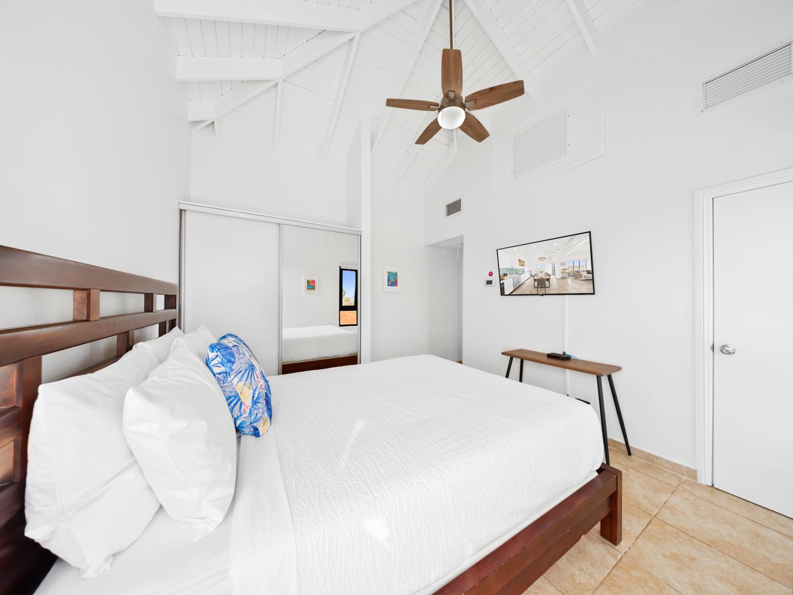 Opulent bedroom of the condo in Noord Aruba - Plenty of closet space and a full length mirror - Well-appointed bedroom with neutral tones for a calming atmosphere - Smart TV for entertainment