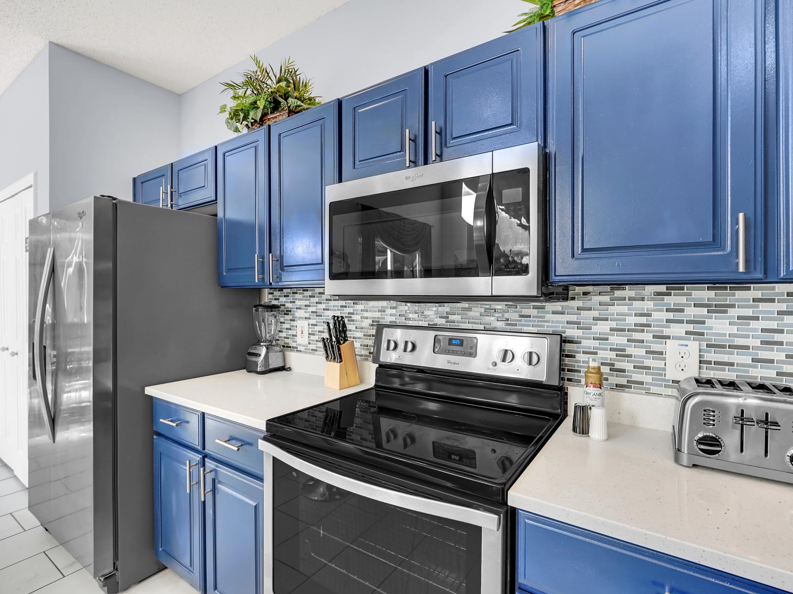 Stylish Kitchen of the Home in Kissimmee Florida - Stainless Steel Appliances - Availability of all kitchen accessories - Elegant lighting - Sufficient space to walk and work according to your ease