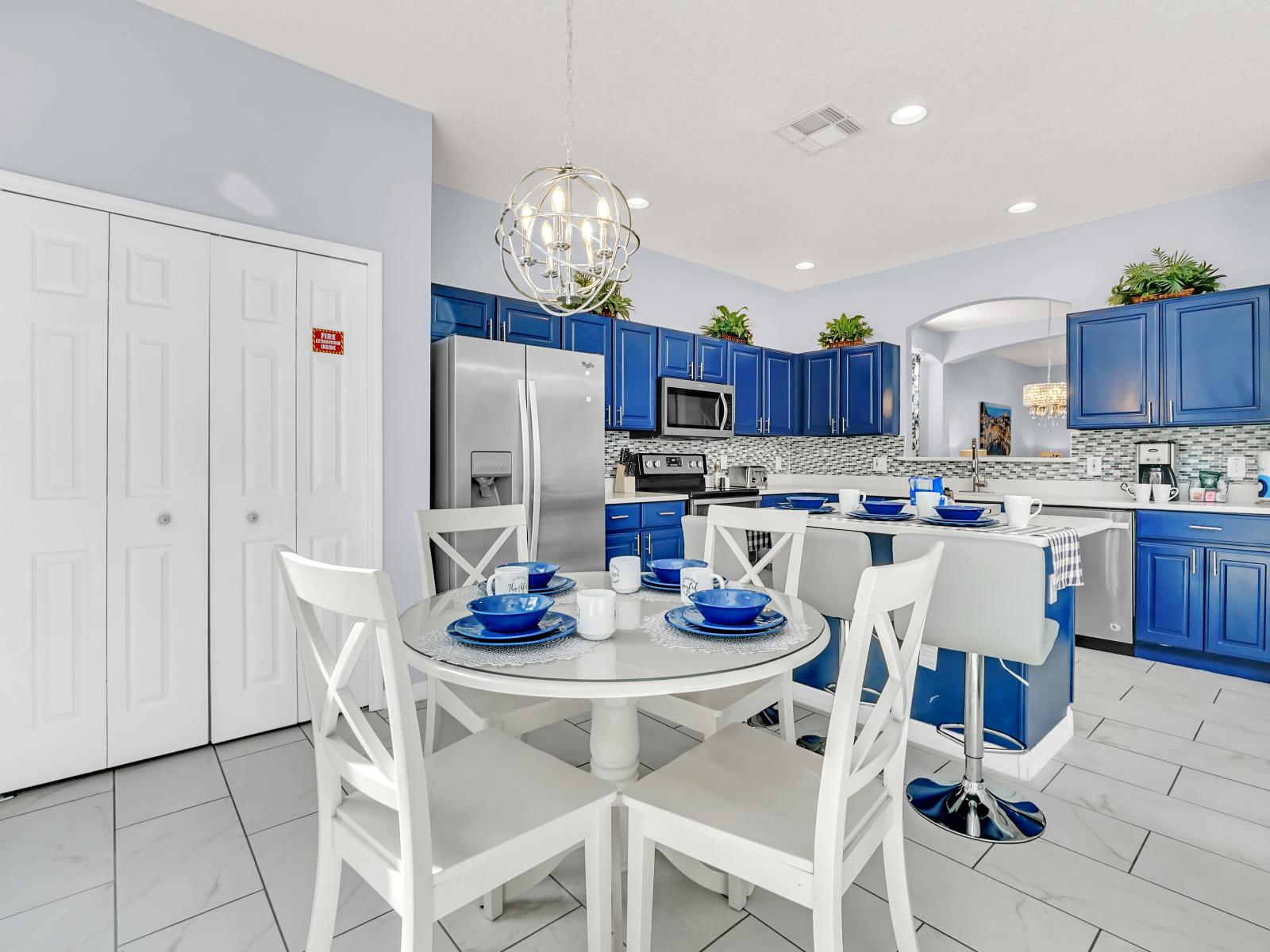 Lush Kitchen of the Home in Kissimmee Florida - 4 Persons dining for casual meals - Integrated appliances for a seamless and stylish appearance - Breakfast bar with high chairs