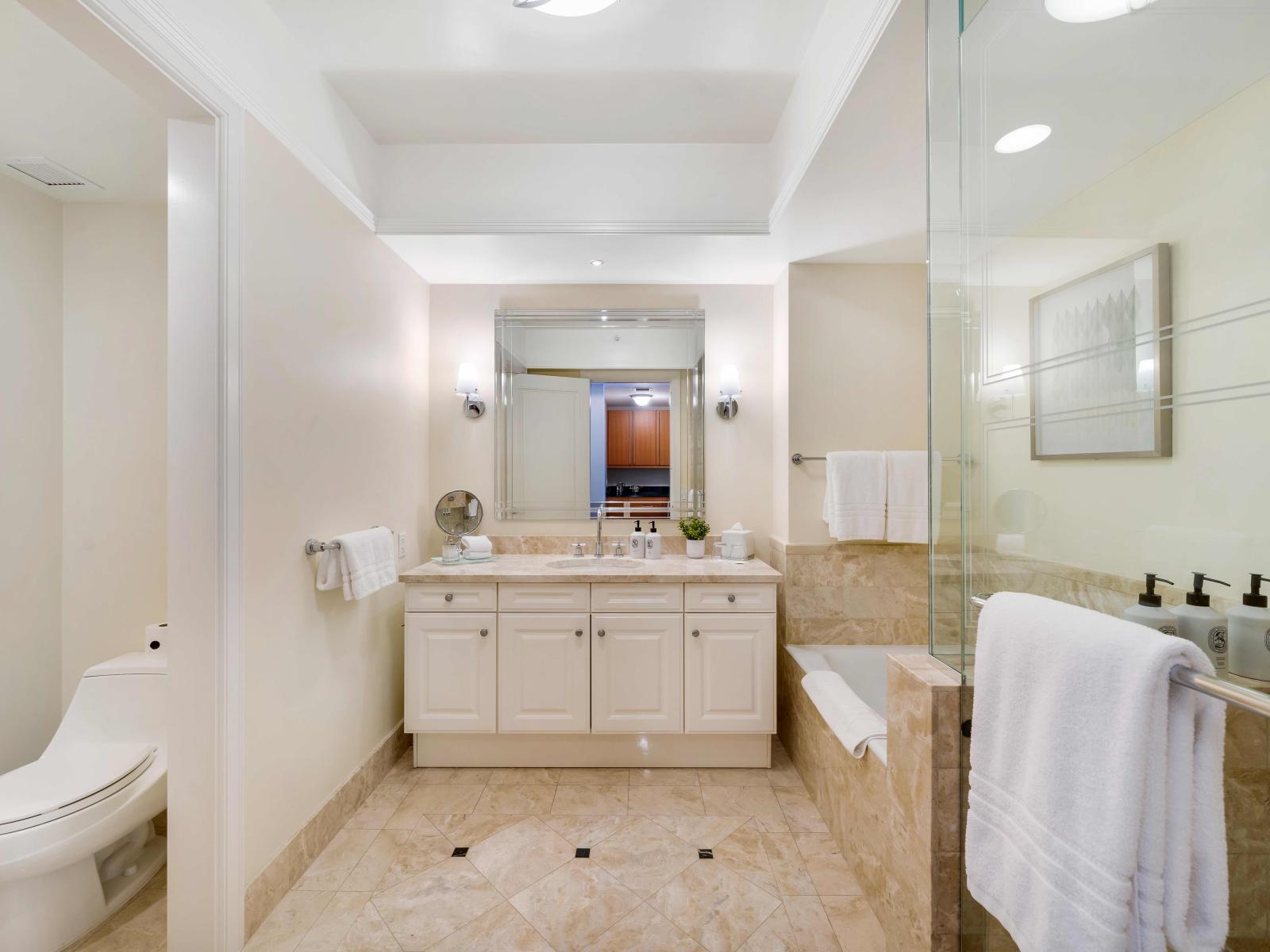 Miami Majesty: Unwind in this luxurious bathroom, where a walk-in shower and elegant bathtub await your indulgence. The epitome of comfort and style in the heart of Miami's vibrant scene.