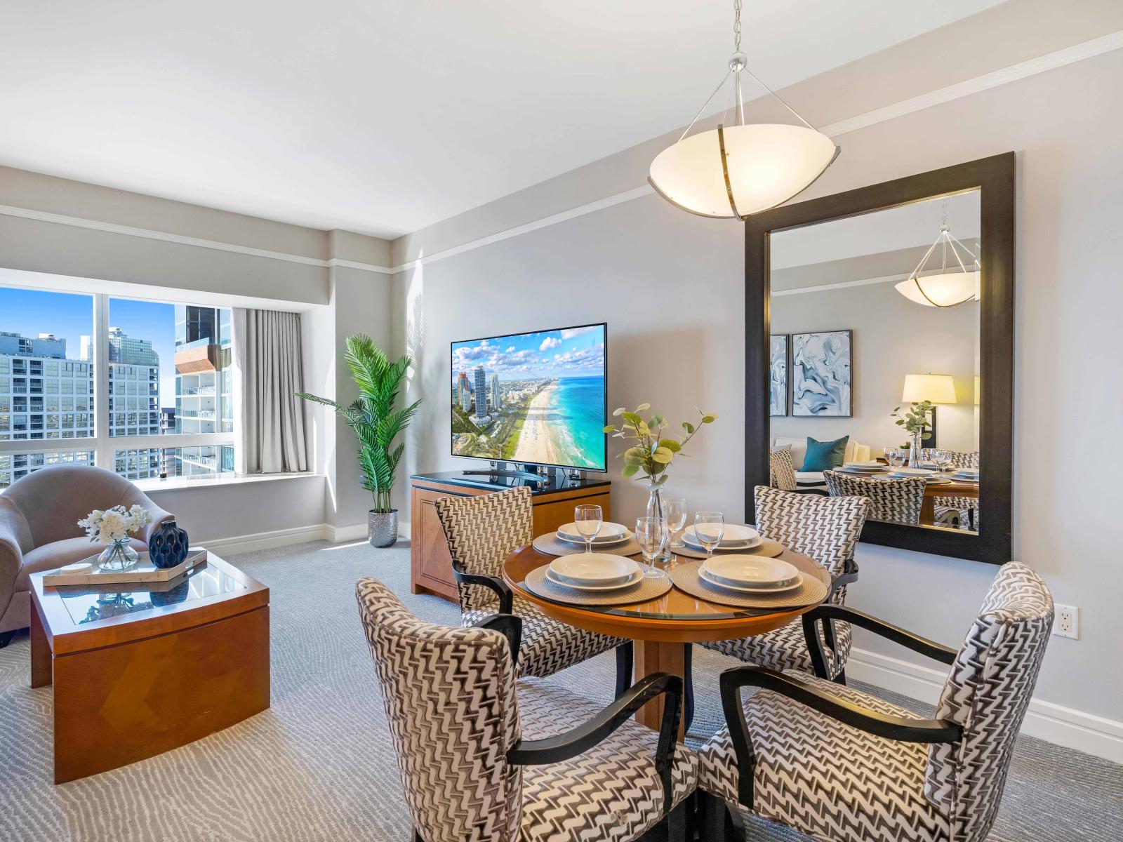 Urban Elegance: Experience dining with a view in this studio apartment's chic dining area. A tasteful setup that combines comfort with contemporary design, providing the perfect spot to savor your Miami culinary experiences.