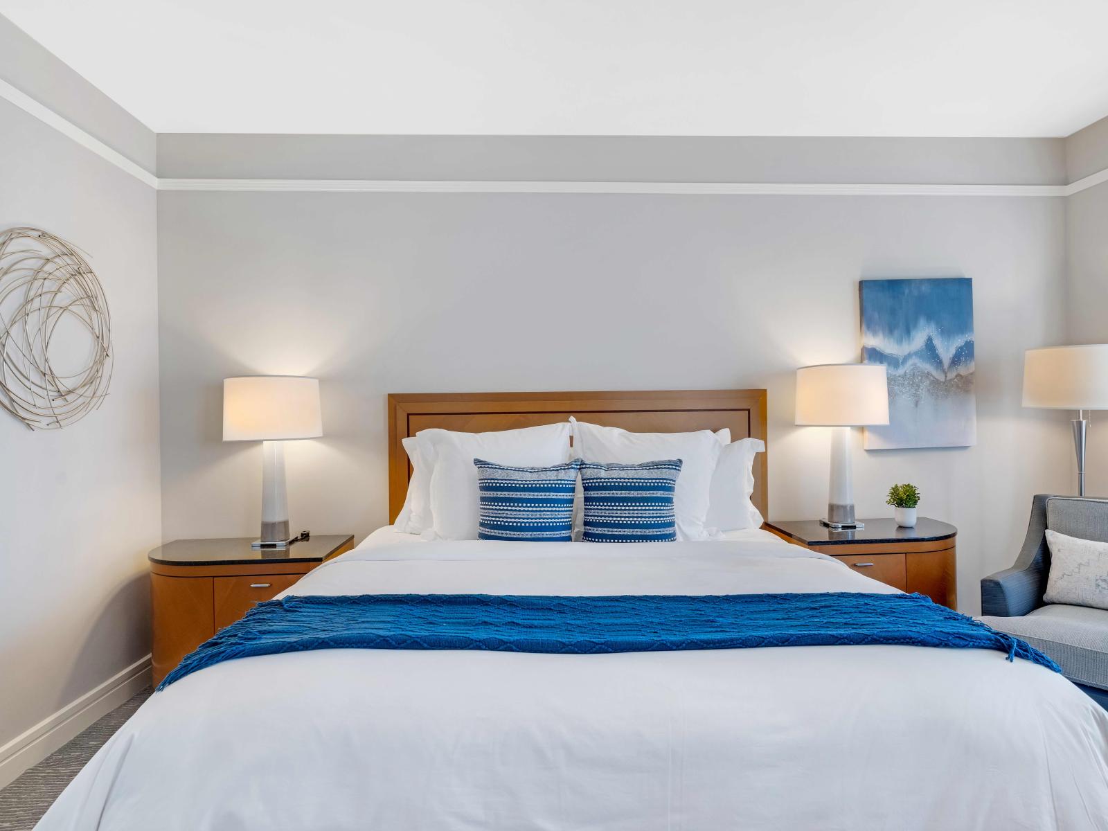 Elevate Your Stay: Indulge in Luxury with Our Ocean View Bedroom Suite, Complete with a King-Size Bed, Smart TV, Private Bathroom, and Work Desk.