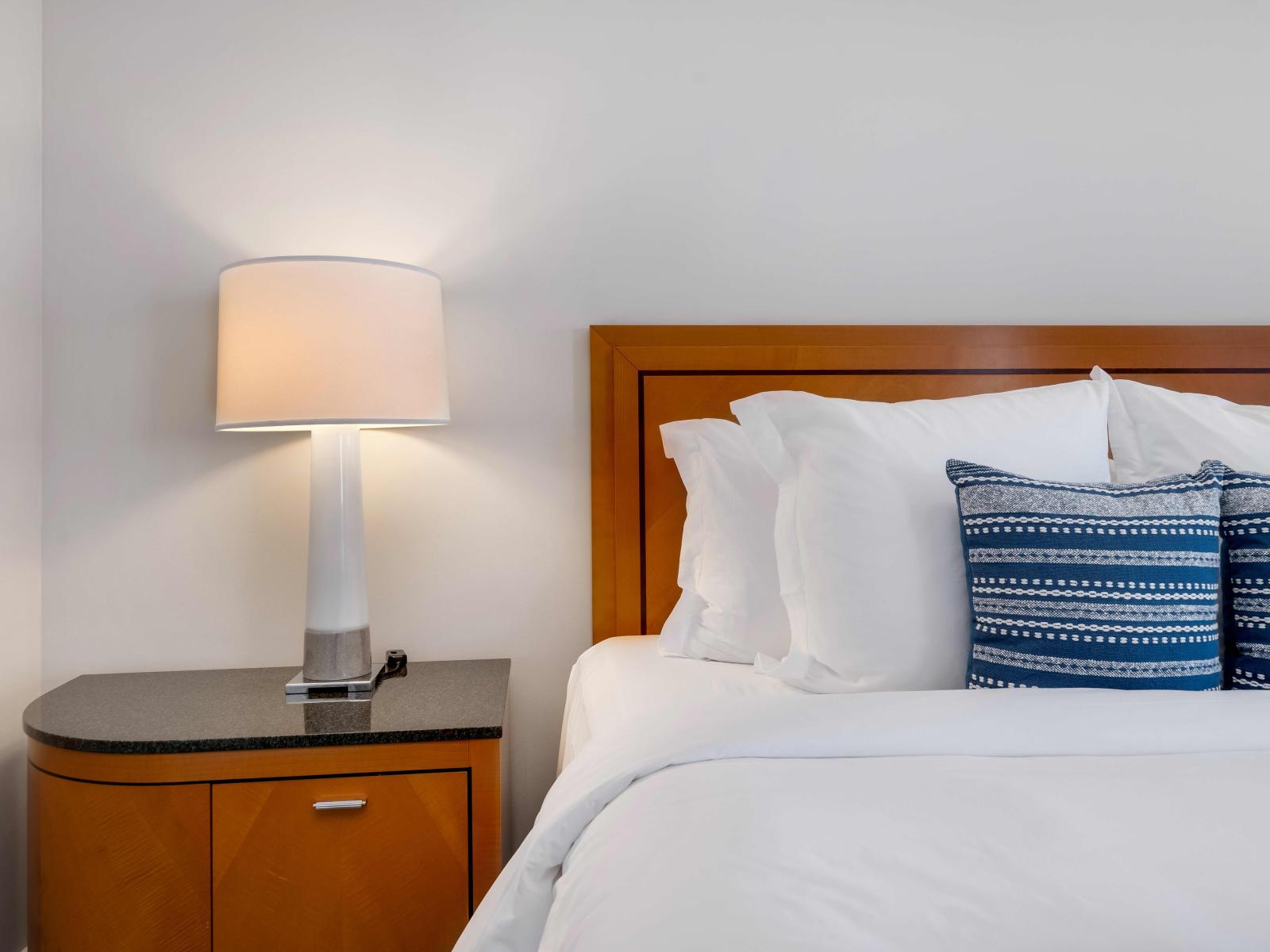 Coastal Comforts: Experience Blissful Relaxation in Our Bedroom Suite, Offering Unforgettable Ocean Vistas, a Sumptuous King Bed, Smart TV Entertainment, Attached Bathroom, and Convenient Work Desk.