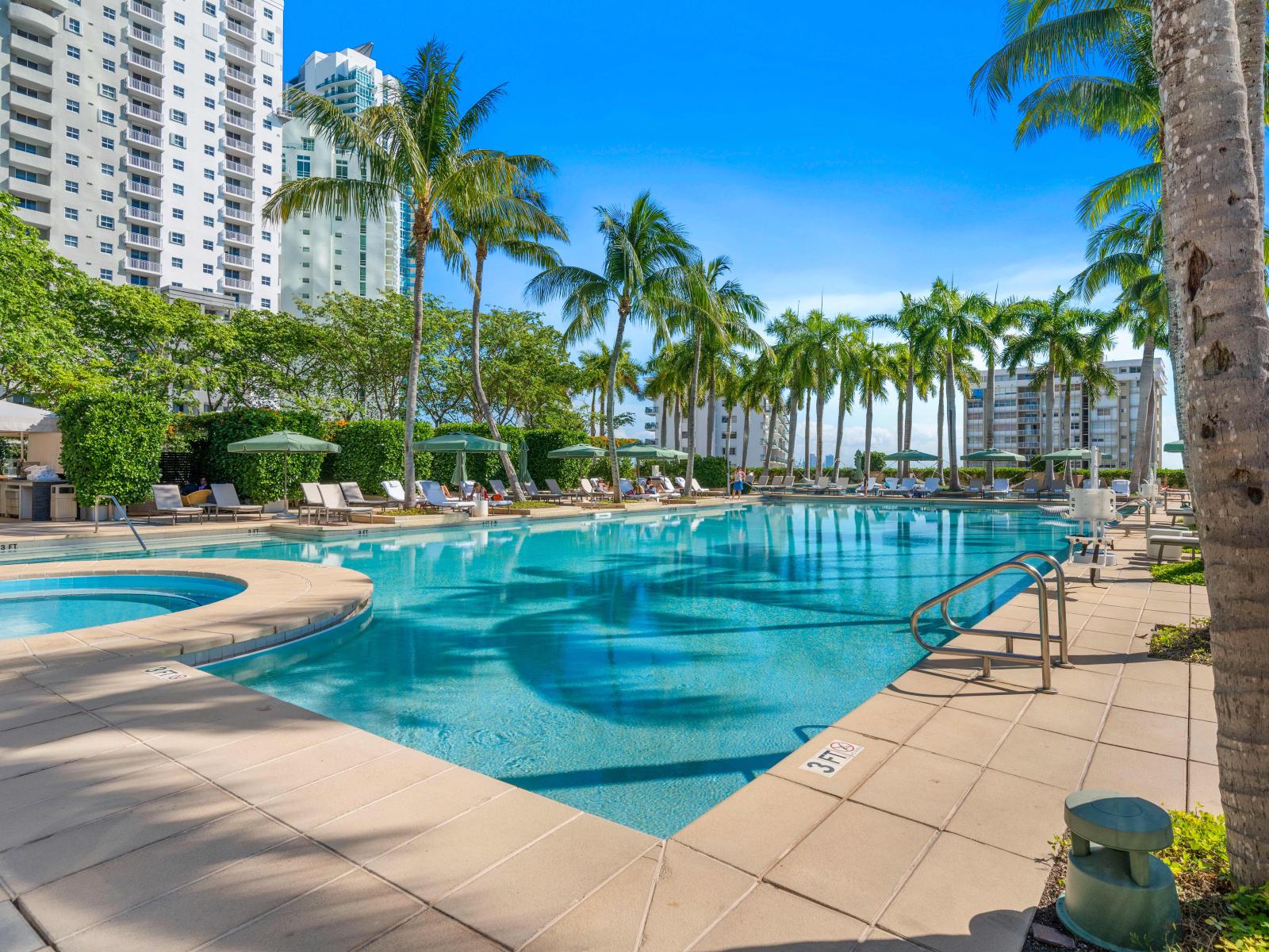 Resort Pool in Miami Florida - Relax by the shimmering poolside oasis - Dive into a refreshing poolside escape - Provides a relaxed atmosphere for unwinding