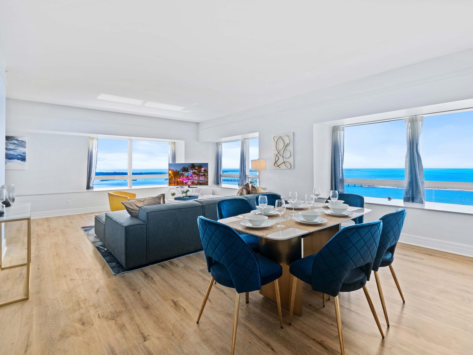 Eclat Living and dining area of the Condo in Miami Florida - Splendid Ocean Views from panoramic windows - Smart TV and Netflix - Harmonious color scheme with pops of accent colors for visual interest - Plush sofas