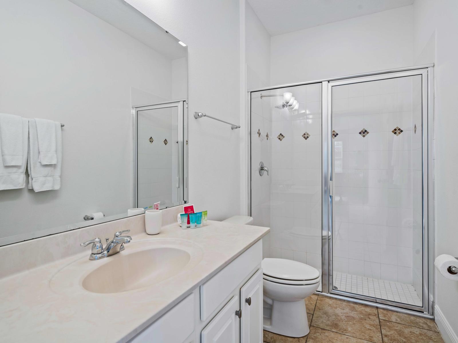 Exclusive Bathroom of the home in Davenport - Glass Cabin walk-in shower area - Neat and clean toilet seat - All bathroom amenities available with fresh towels - Vanity with large size mirror