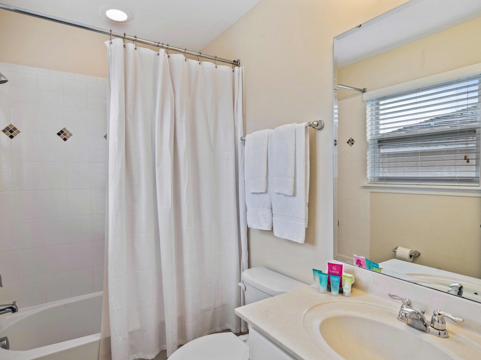 Refresh and rejuvenate in our elegant and tranquil bathroom of the home in Davenport - Experience ultimate comfort in our sleek bathroom with Bathtub and neat toilet seat - Glorious sink with wall mirror