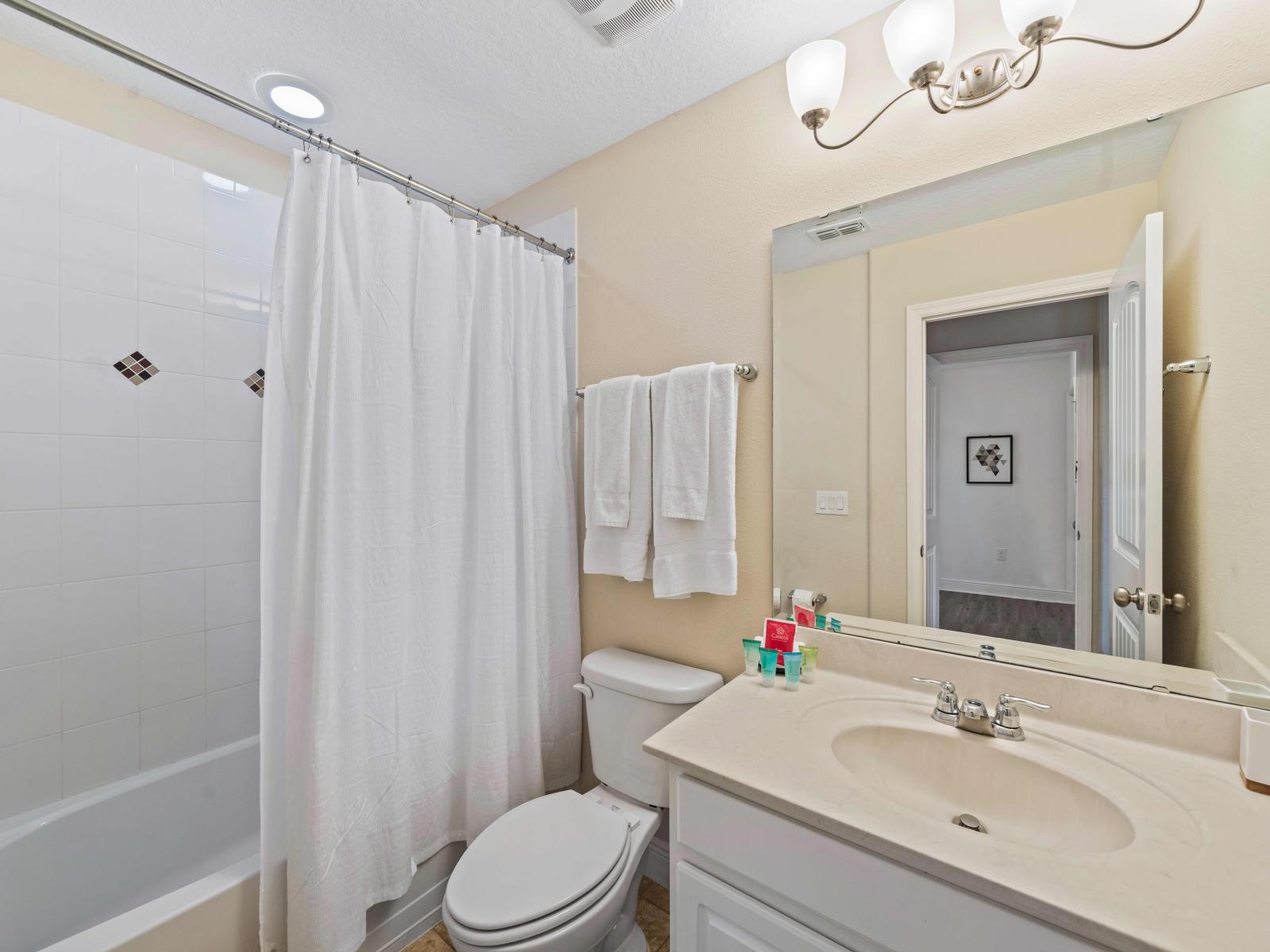 Enjoy privacy and comfort in this beautifully designed bathroom of the home in Davenport - Soft lighting and heated floors provide a cozy atmosphere. -  Indulge in the spa-like atmosphere with a spacious soaking tub and rainfall showerhead.