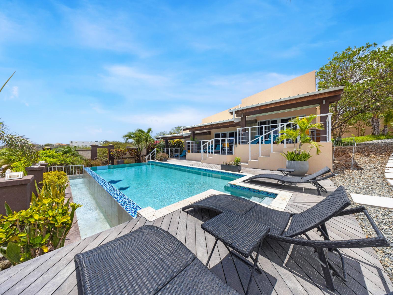 The apartment’s inviting pool area, harmoniously integrated into the lush natural surroundings