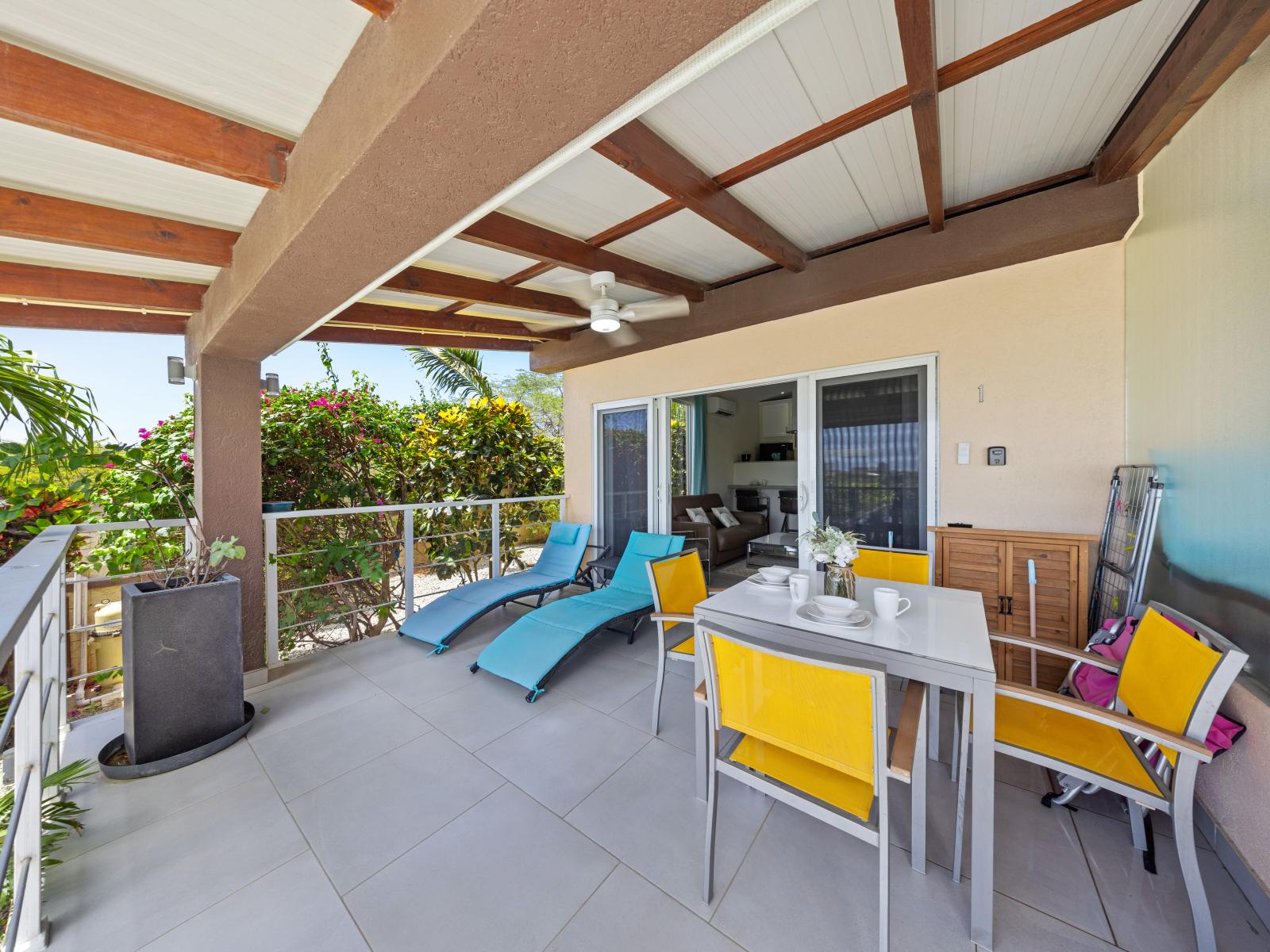 Cozy lounge chairs and outdoor dining table on the private patio