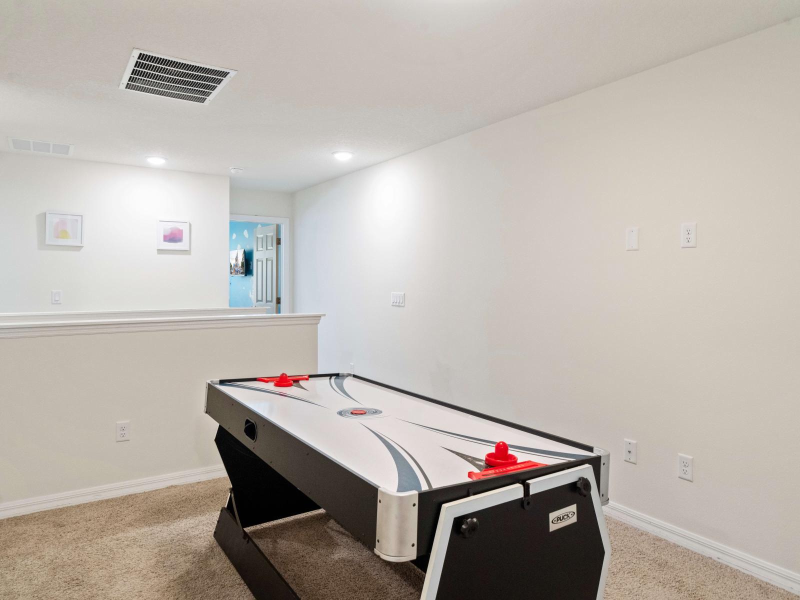 Fun Loft area of the Townhouse in Kissimmee. - Loft with an air hockey table and pool table. - Level up your vacation experience with air hockey fun for all ages! - Create unforgettable memories.