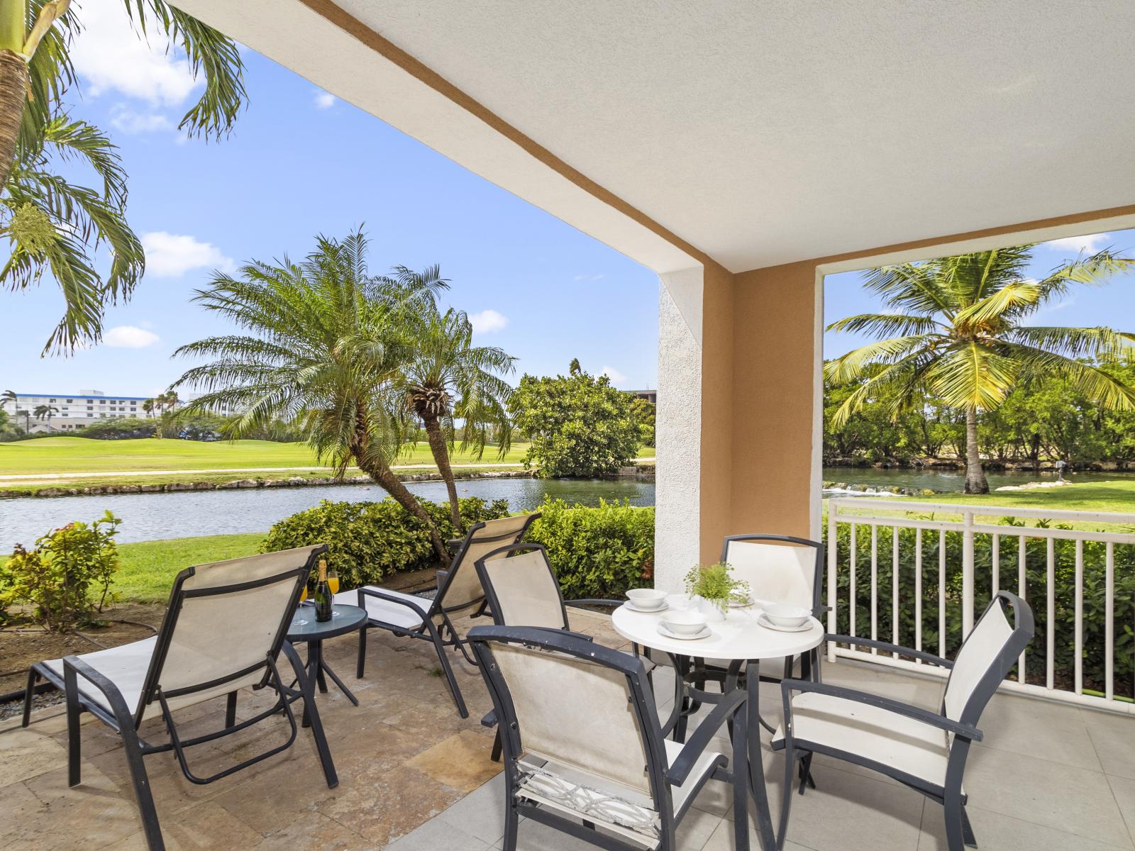 Step out from this first-floor condo onto your private patio, where the grass meets the tranquil waters of the lake, offering a serene escape right at your doorstep