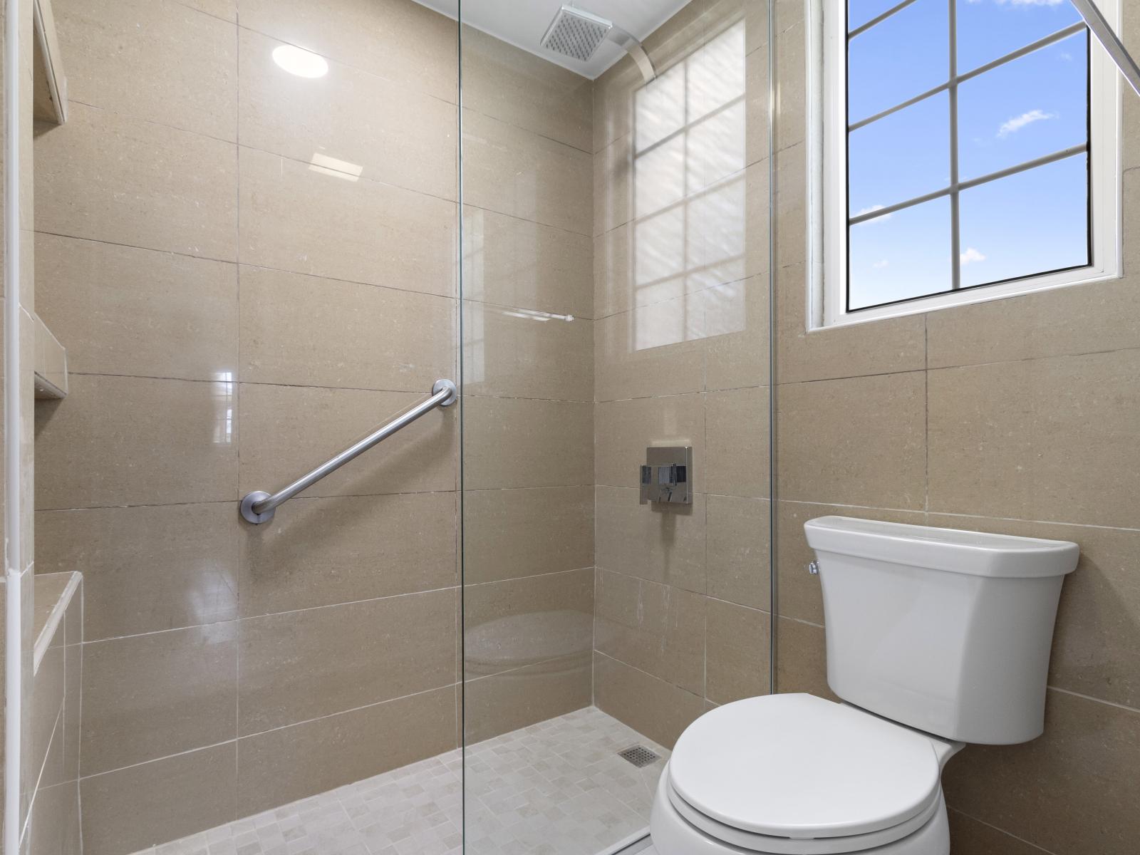 Pamper yourself in Bathroom 1, featuring a luxurious walk-in shower for a refreshing start or end to your day.