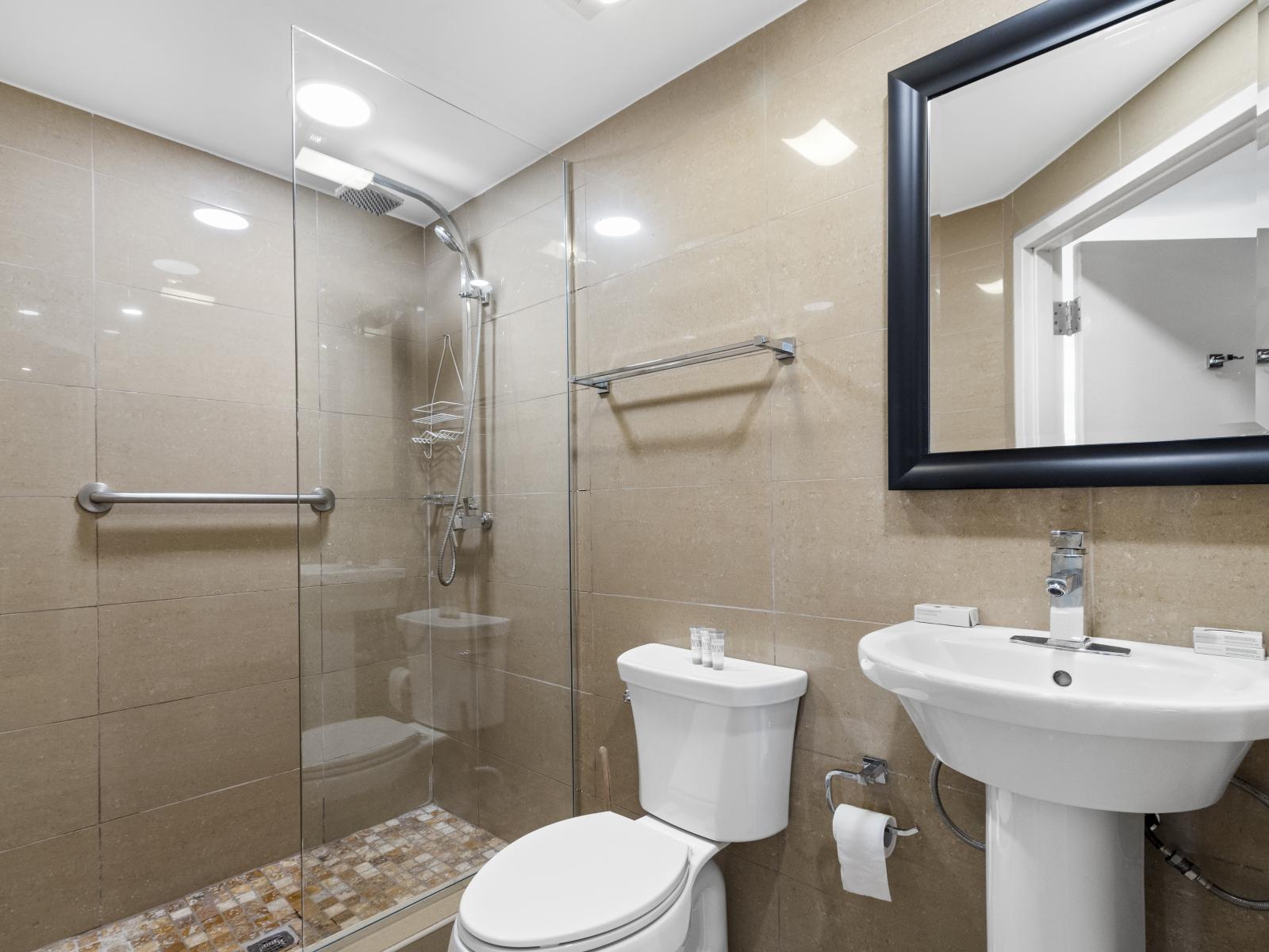 Enjoy the modern luxury of Bathroom 2, featuring a spacious walk-in shower for a refreshing experience.