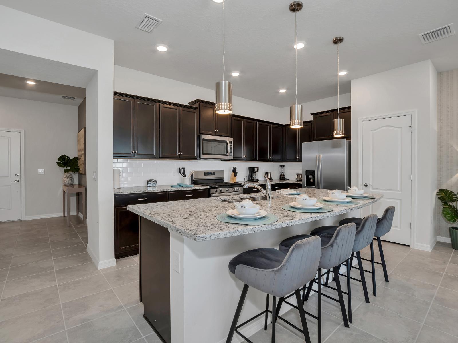 Modern kitchen of the townhouse in Davenport Florida  - Full equipped - Contemporary design with clean lines and minimalist aesthetics - Breakfast bar and high chairs