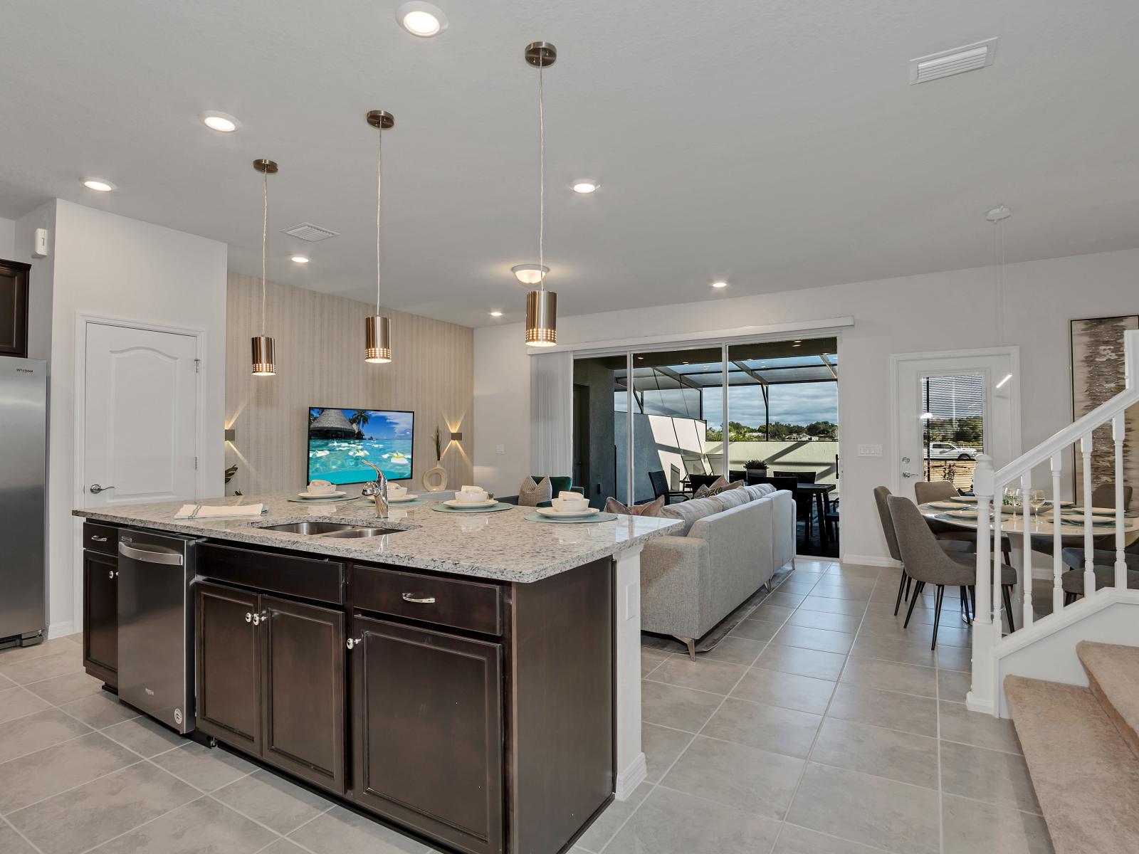 Full equipped kitchen of the townhouse in Davenport Florida - Open layout seamlessly connecting the dining area to the kitchen and living area - Thoughtful placement of kitchen essentials for easy access - Stainless steel appliances