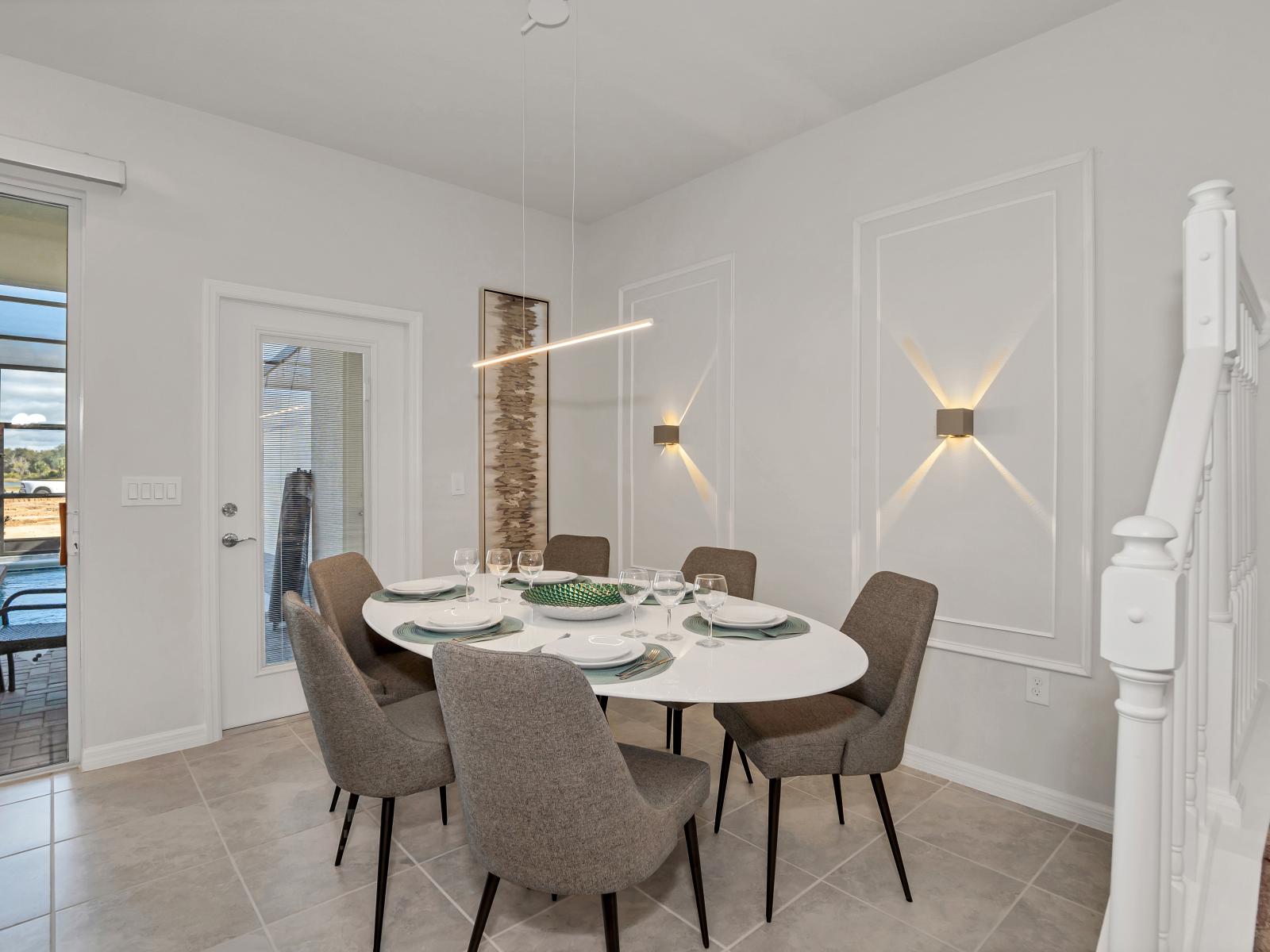 Sleek dining area of the townhouse in Davenport Florida - 6 Persons dining - Chic dining area featuring a stylish table and contemporary seating - Neutral color palette with pops of vibrant hues for a chic contrast