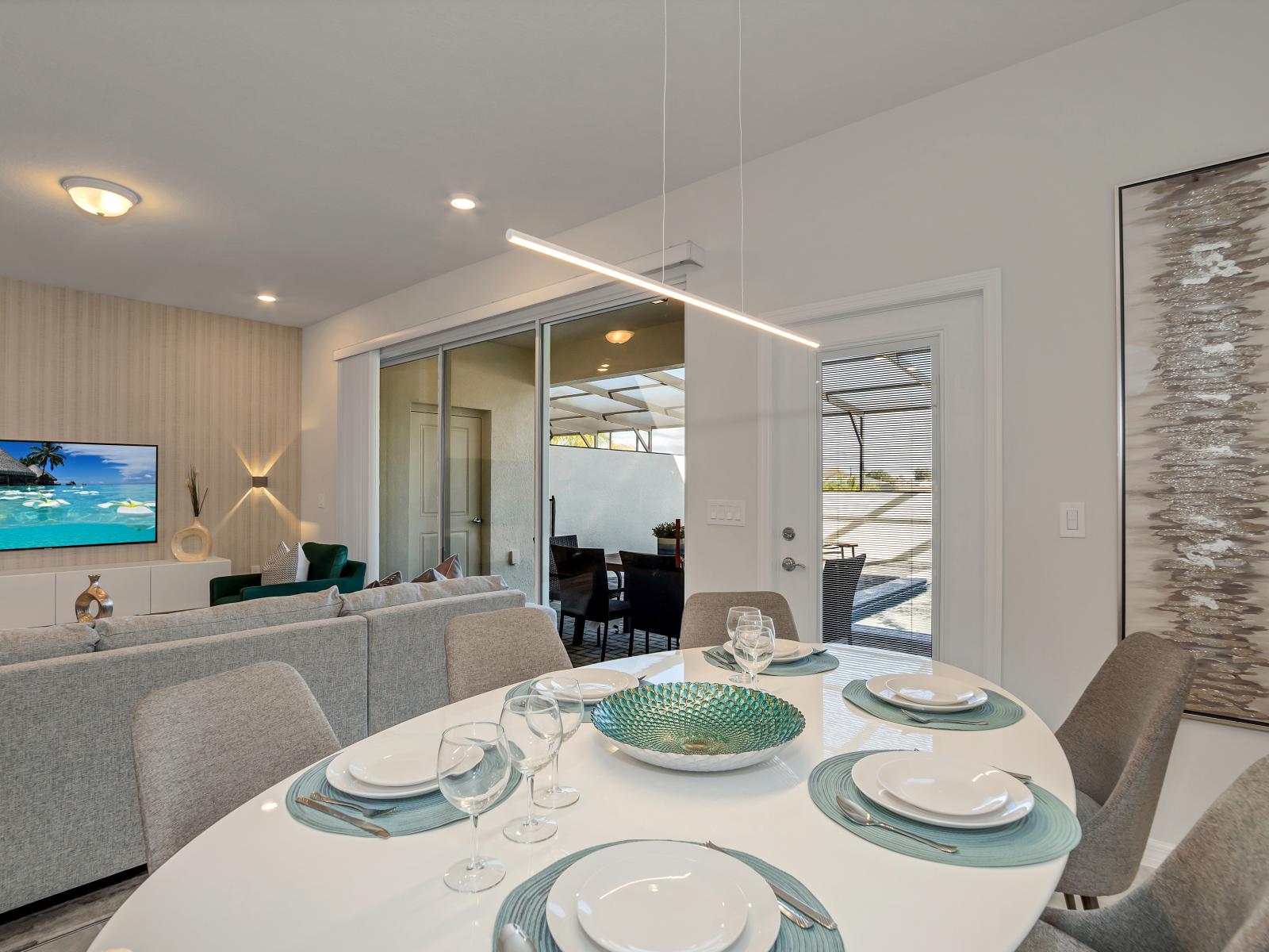 Elegant dining area of the townhouse in Davenport Florida - Sophisticated design with a blend of modern and classic elements - Artfully arranged table settings for a touch of elegance - Open layout seamlessly connecting the dining to the living