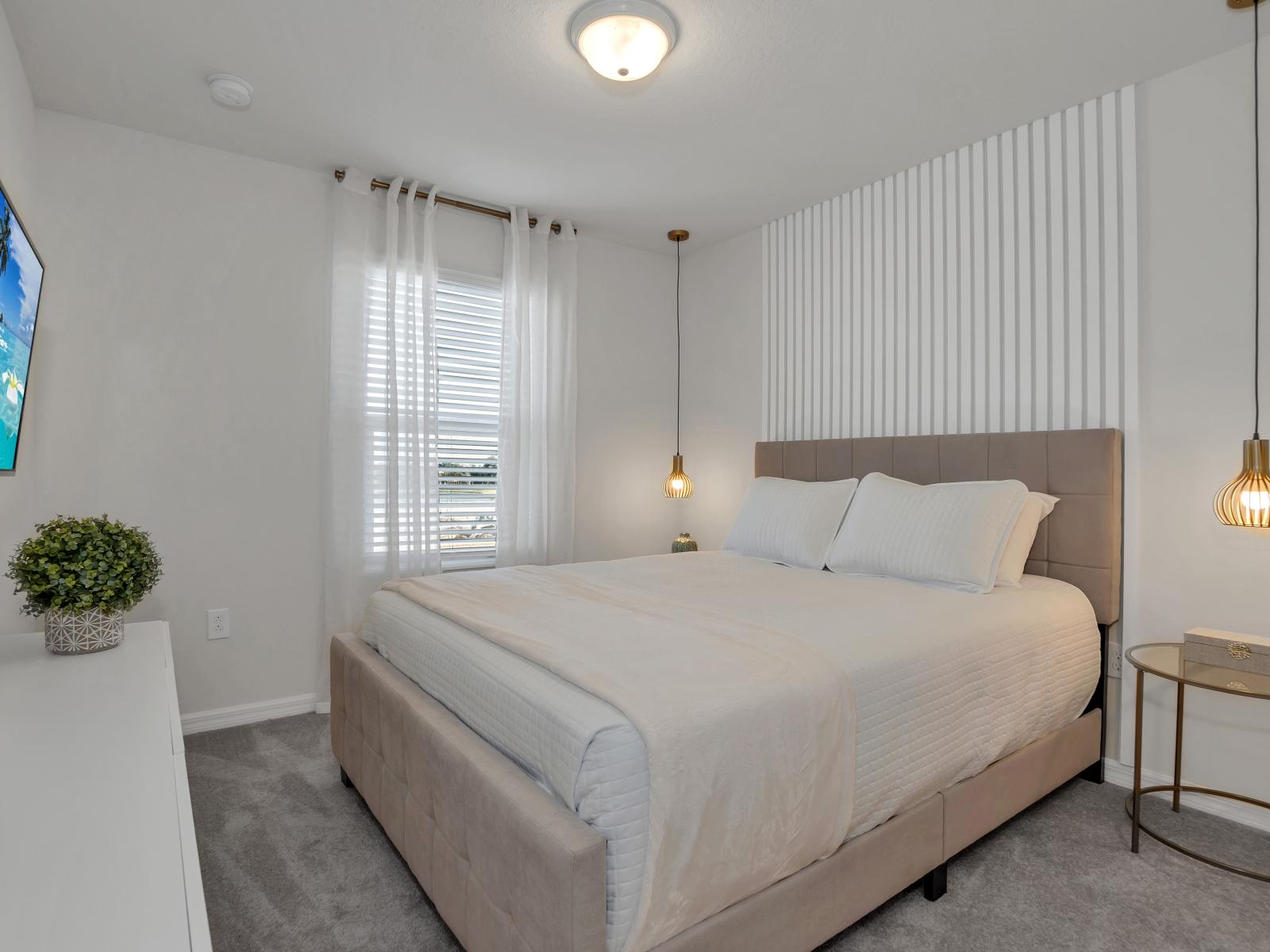 Elegant bedroom of the townhouse in Davenport Florida - Offering comfy double bed and a private bathroom - Minimalist decor, creating a clean and uncluttered sleeping space - Indoor potted plants for nature's touch