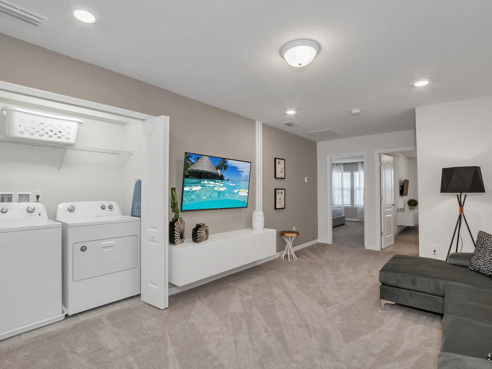 Loft area of the townhouse in Davenport Florida - Offers with smart TV and seating area - Contemporary design elements and upscale finishes - Laundry area for convenience