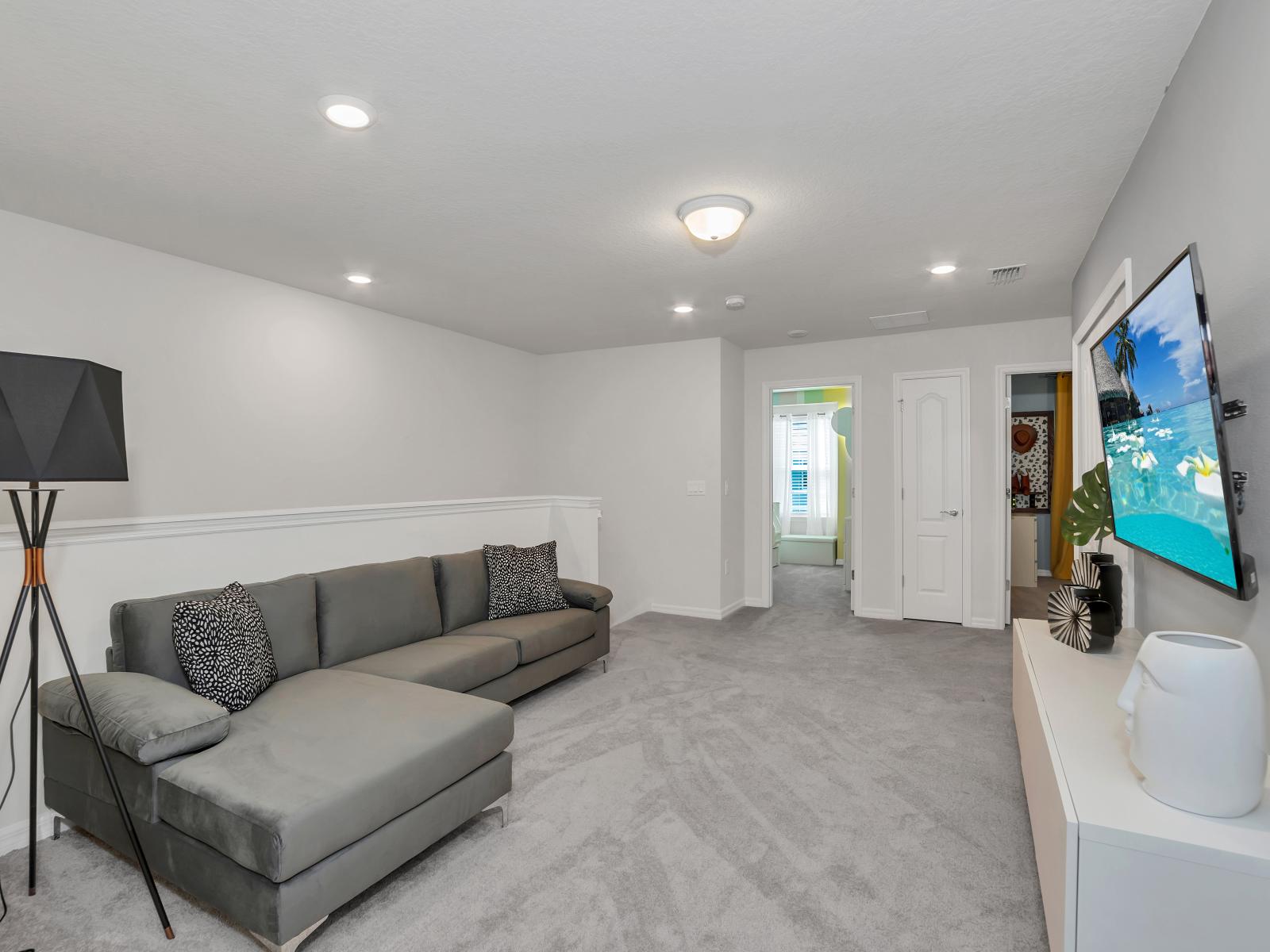 Loft area of the townhouse in Davenport Florida - A welcoming space where you can create cherished memories with loved ones - Entertainment hub with smart TV and plush sofa - Peaceful surroundings