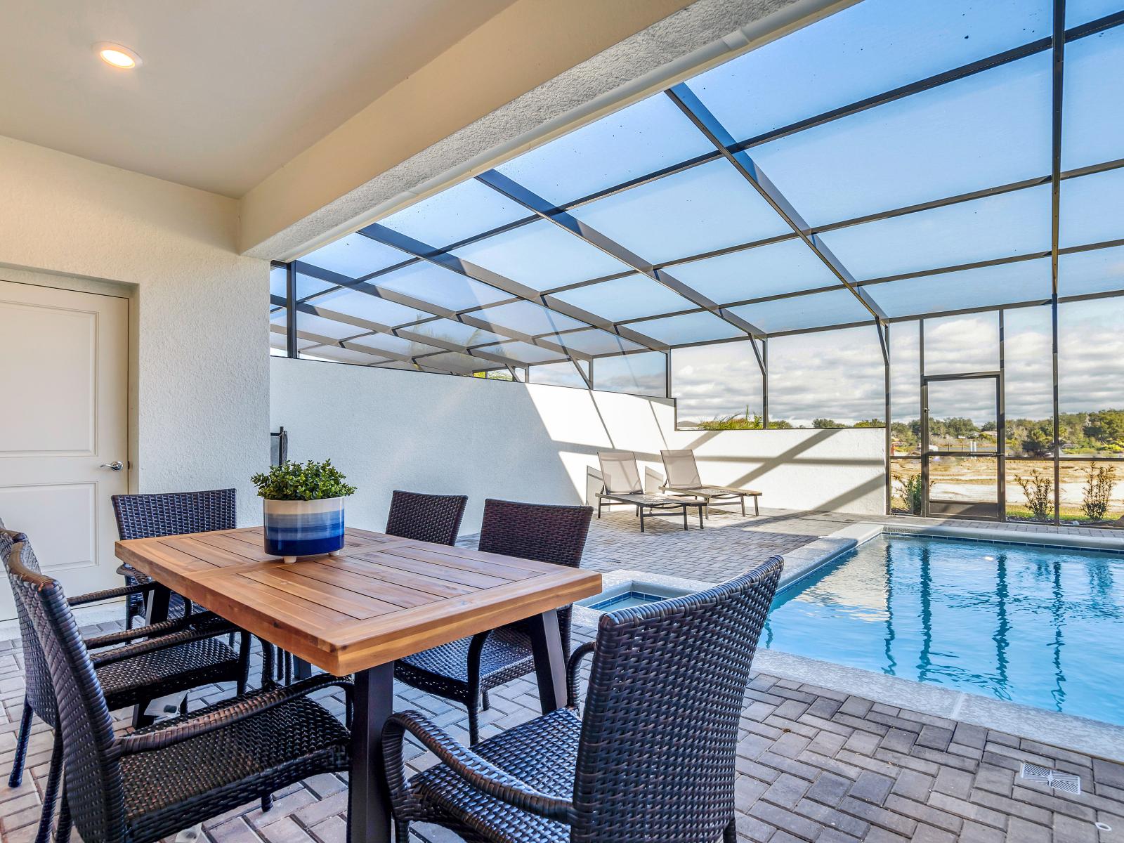 Lush outdoor dining area of the townhouse in Davenport Florida -  Savor the flavors of paradise with a side of poolside serenity - Outdoor dining experience offers a feast for the senses - Every meal accompanied by stunning pool views